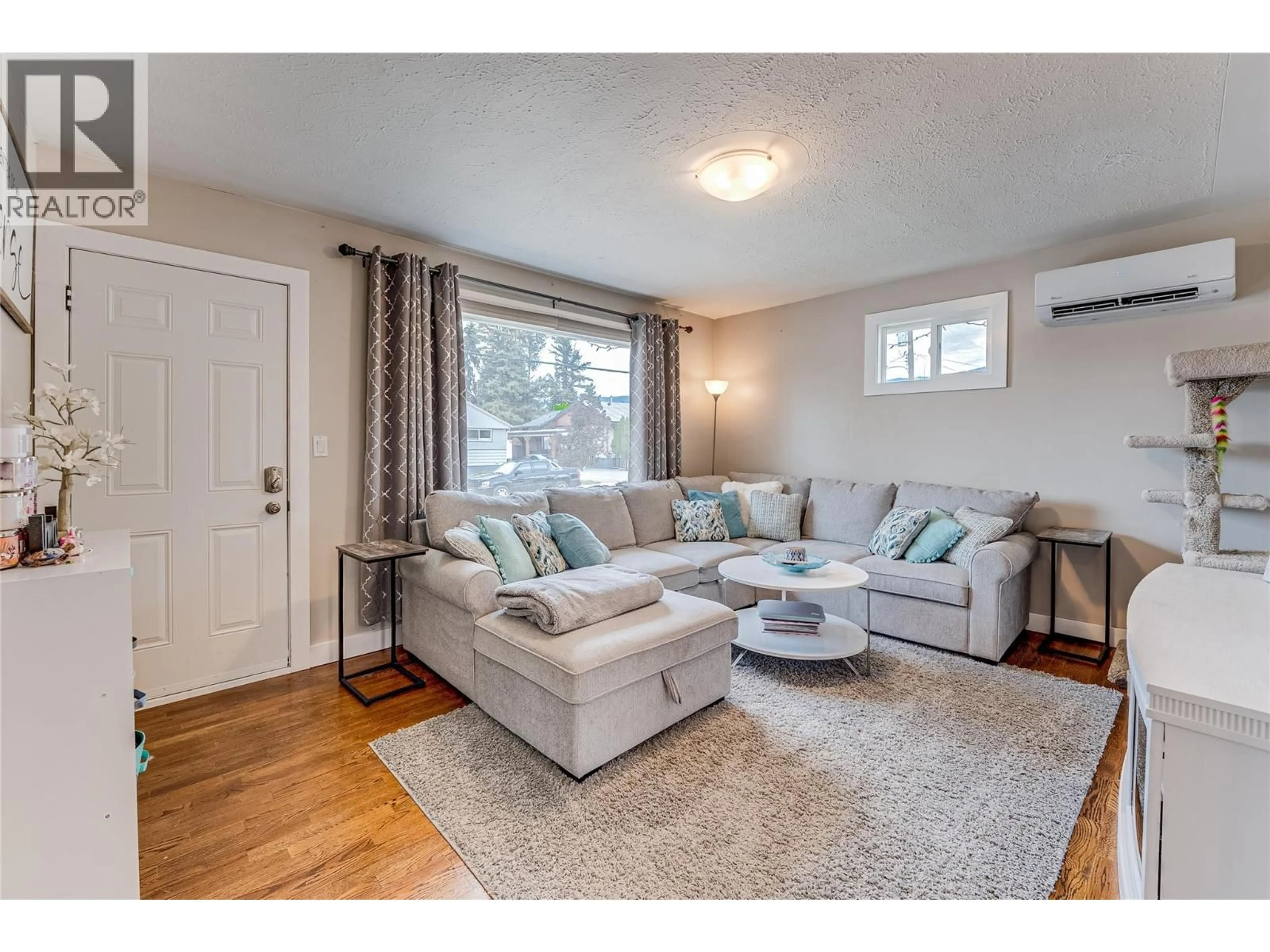 Living room with furniture, wood/laminate floor for 2302 42 AVENUE, Vernon British Columbia V1T3J3