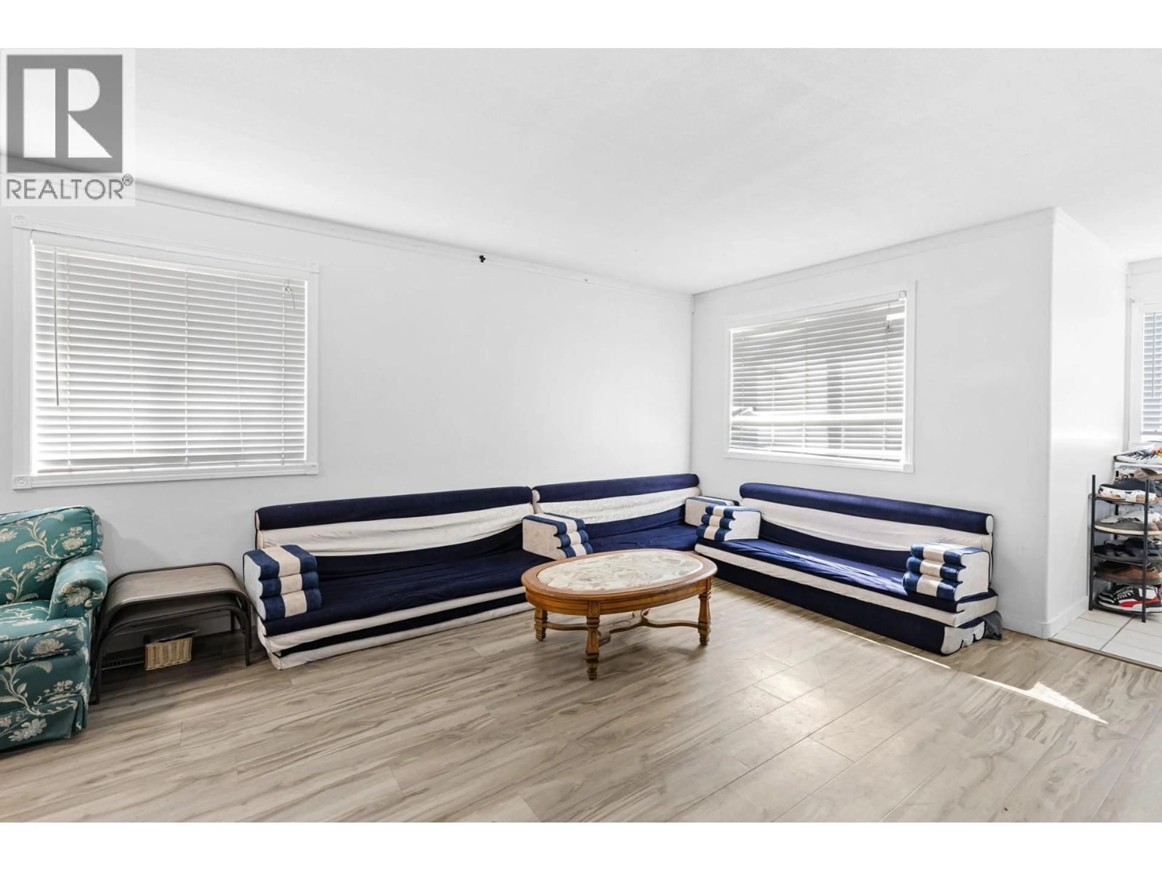 Living room with furniture, wood/laminate floor for 315 GERSTMAR ROAD, Kelowna British Columbia V1X4A6