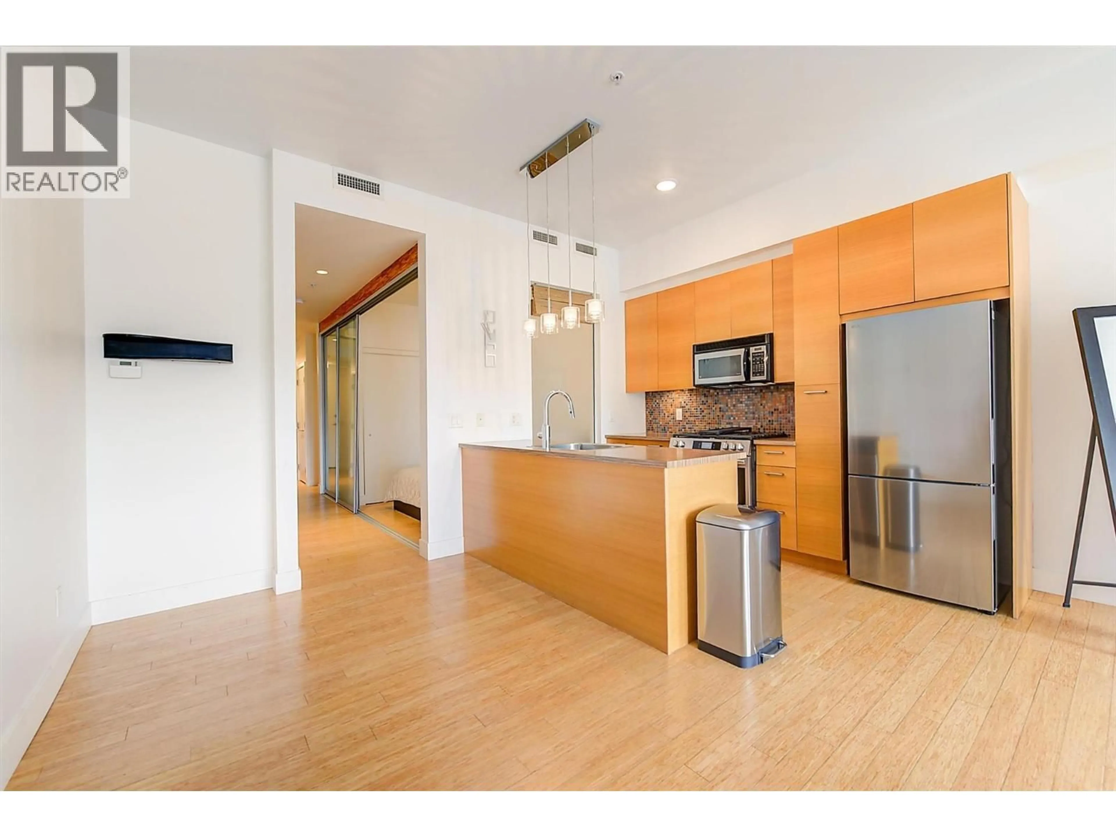 Open concept kitchen, wood/laminate floor for 320 - 1289 ELLIS STREET, Kelowna British Columbia V1Y9X6