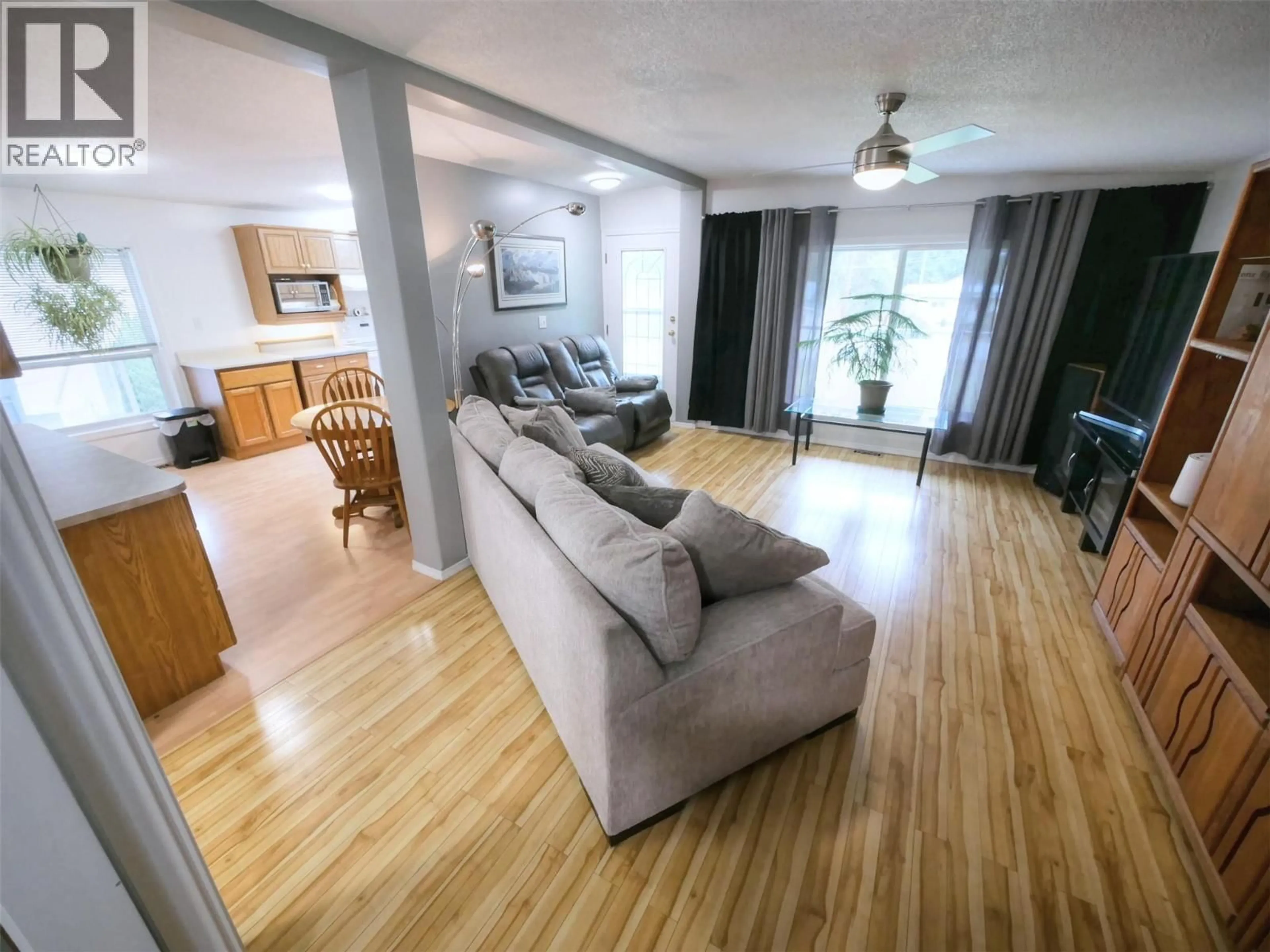 Living room with furniture, wood/laminate floor for 817 SMITH CRESCENT, Genelle British Columbia V0G1G0