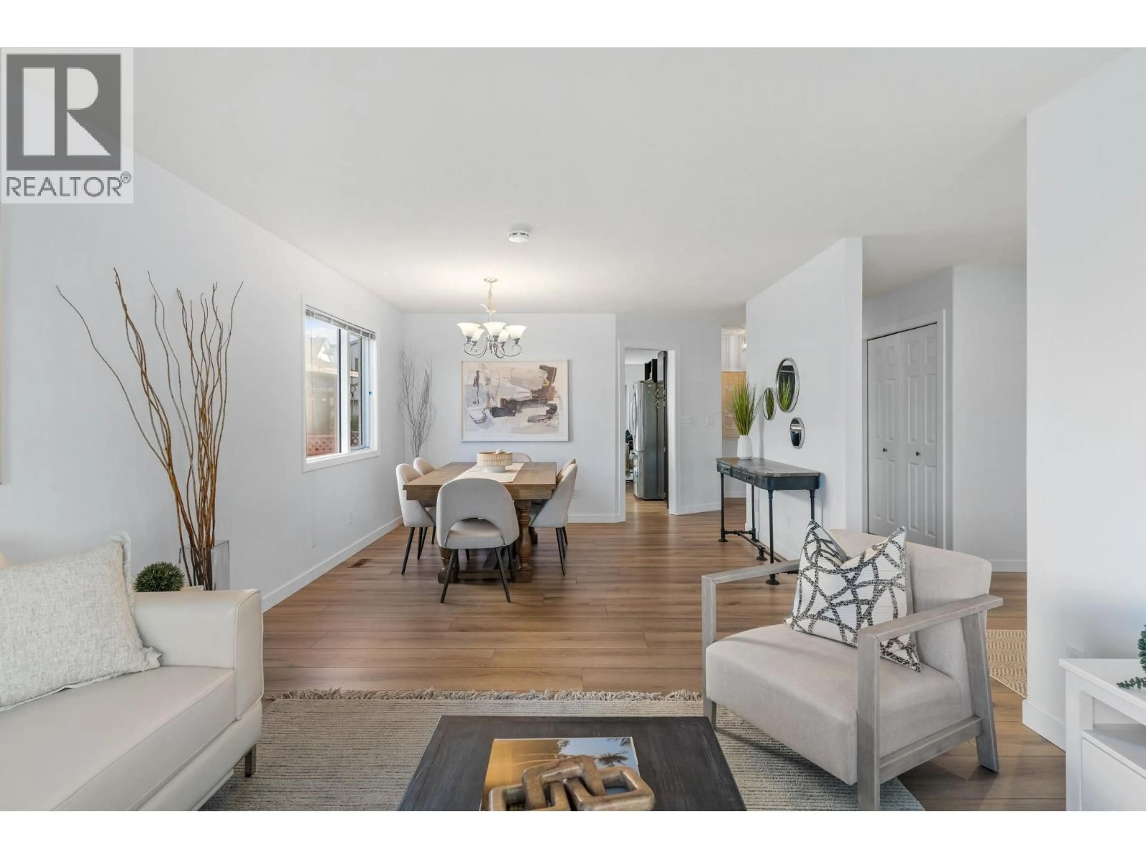 Living room with furniture, wood/laminate floor for 2050 ZINNIA ROAD, Kelowna British Columbia V1V1P5
