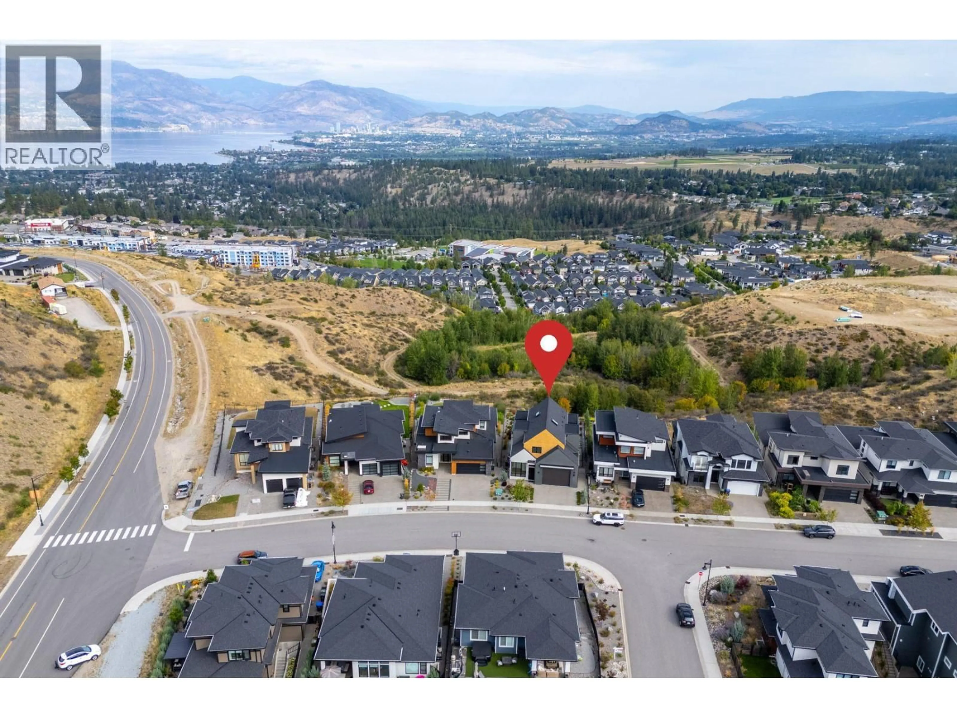 A pic from outside/outdoor area/front of a property/back of a property/a pic from drone, mountain view for 1240 PONDS AVENUE, Kelowna British Columbia V1W5N1