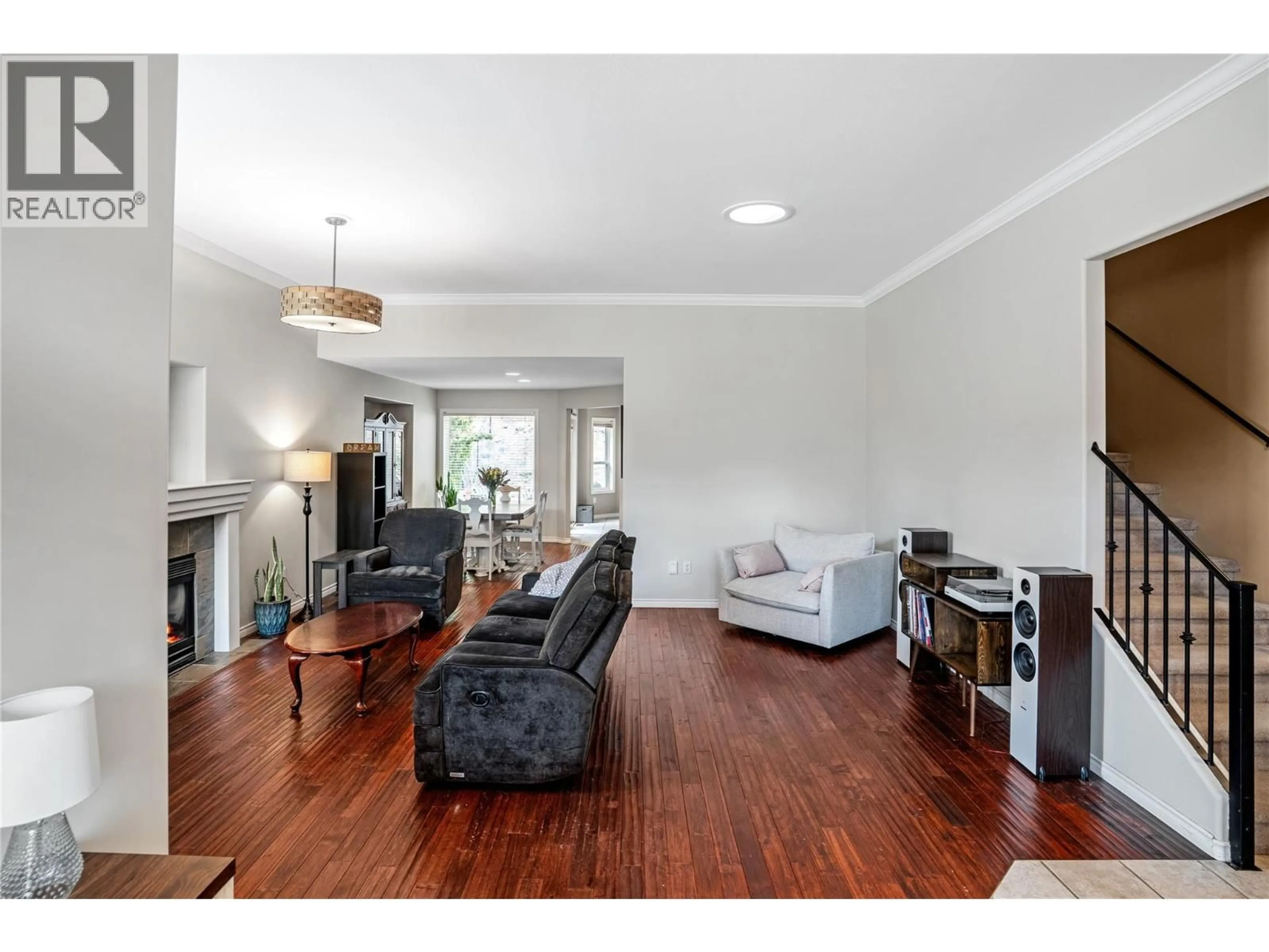 Living room with furniture, wood/laminate floor for 1083 CHILCOTIN CRESCENT, Kelowna British Columbia V1V2L7