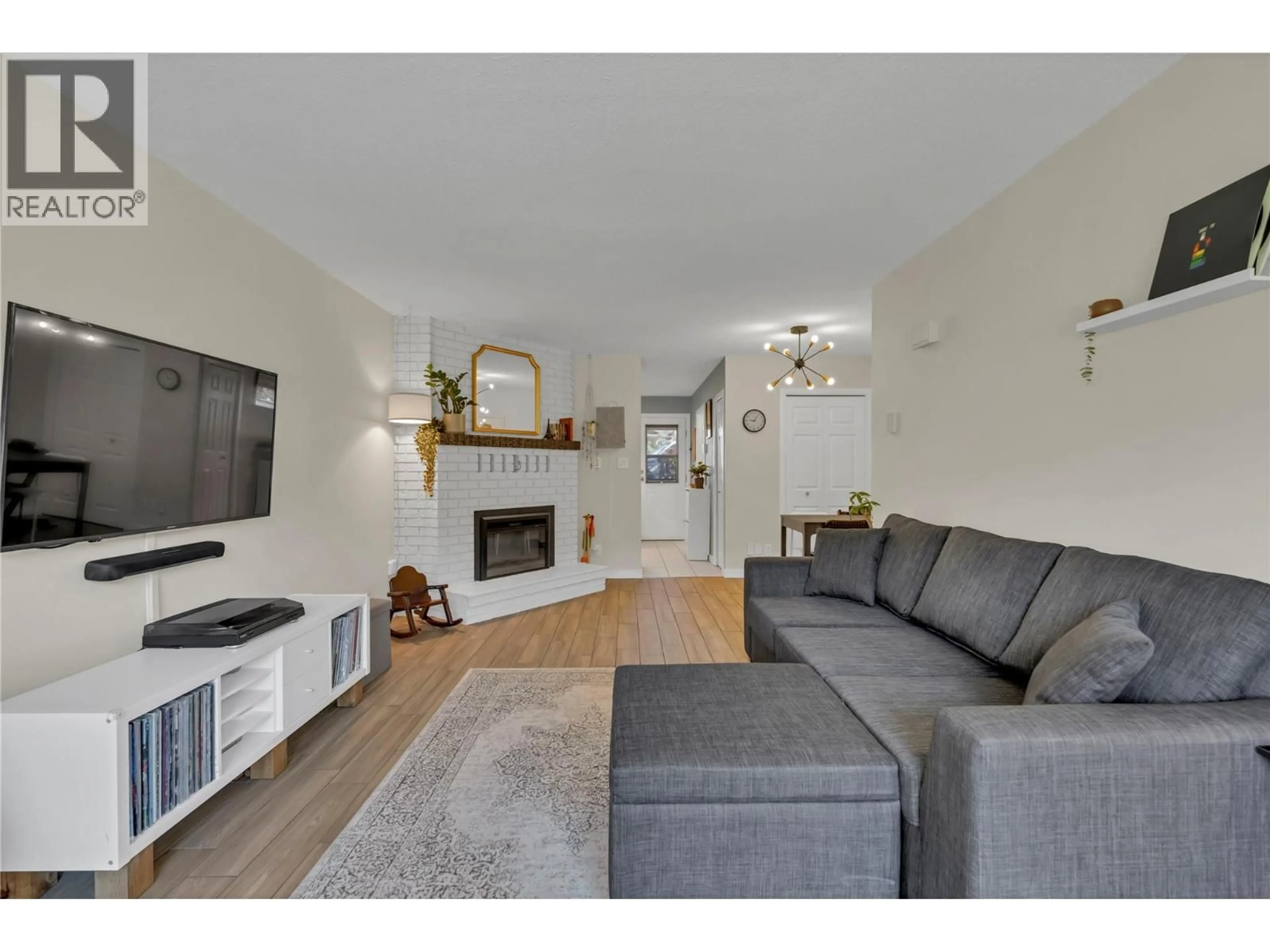 Living room with furniture, wood/laminate floor for 3 - 13707 DICKSON AVENUE, Summerland British Columbia V0H1Z0