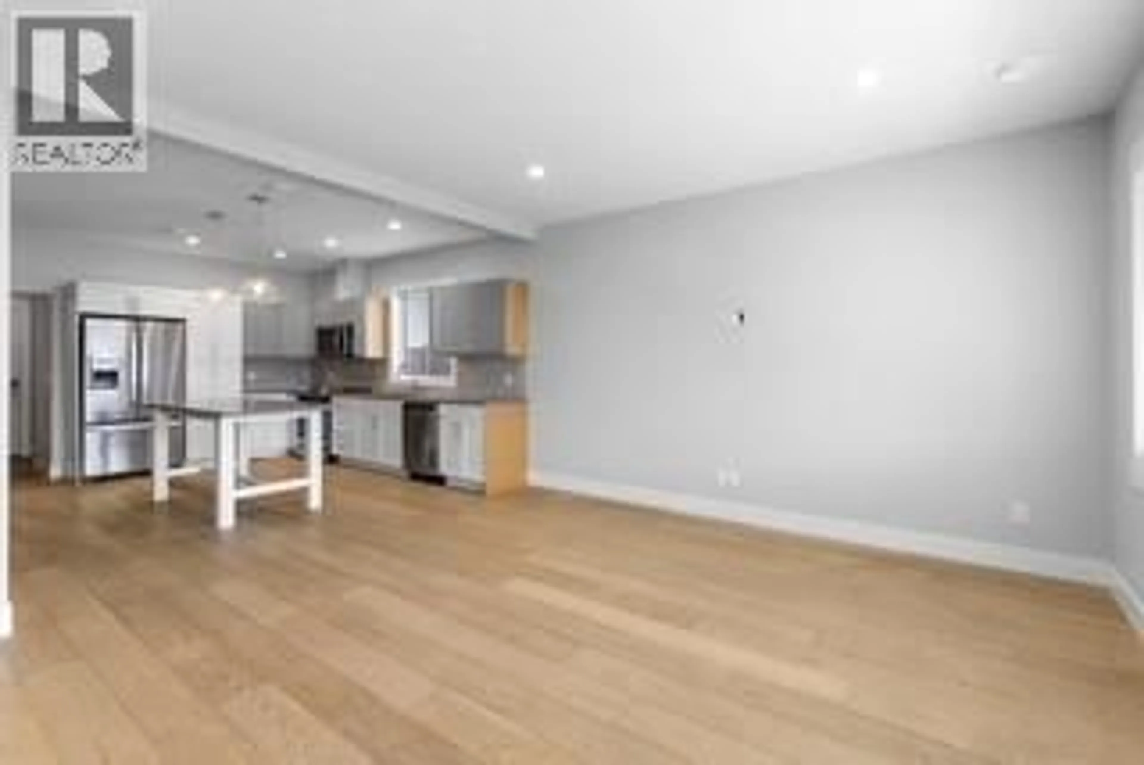 Open concept kitchen, wood/laminate floor for 728 COOPLAND CRESCENT, Kelowna British Columbia v1Y2V1