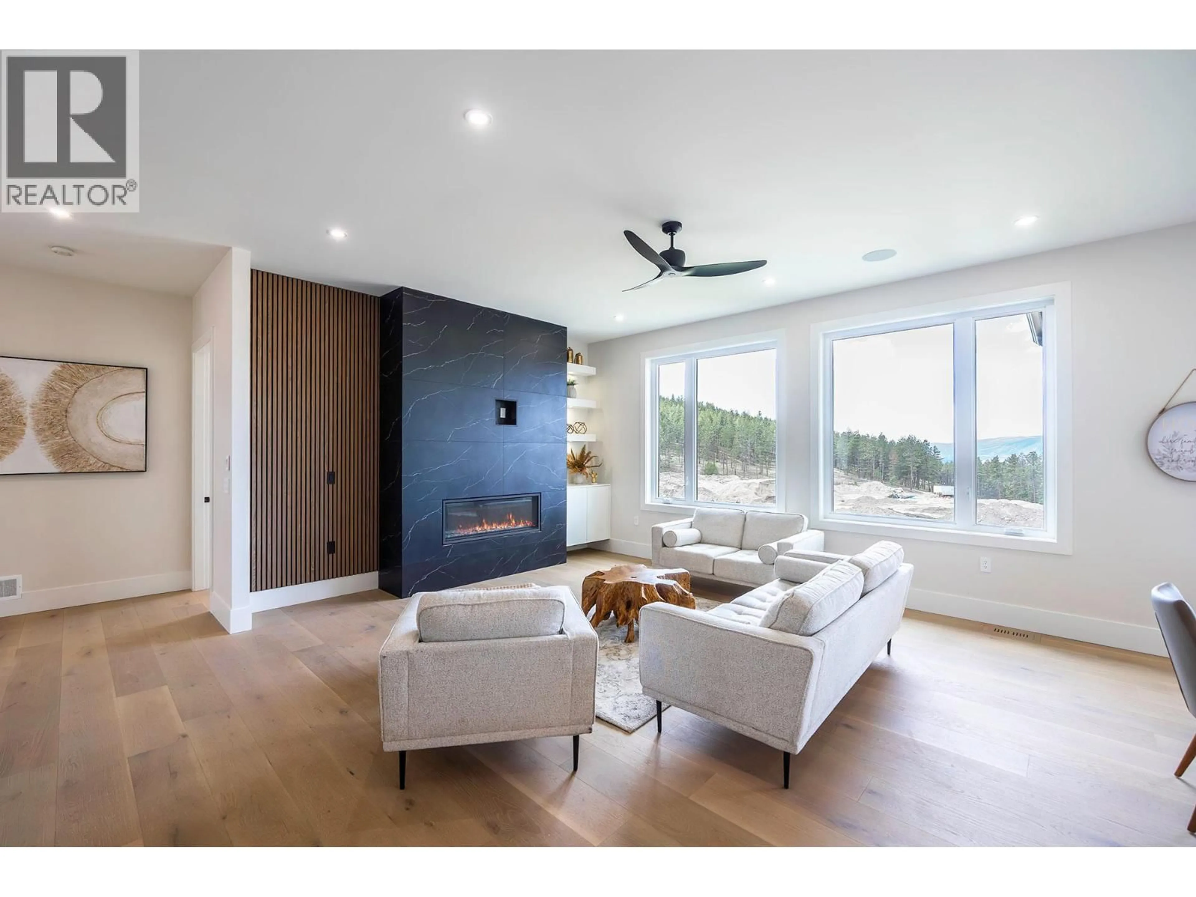 Living room with furniture, wood/laminate floor for 718 CARNOUSTIE DRIVE, Kelowna British Columbia V1P1V2