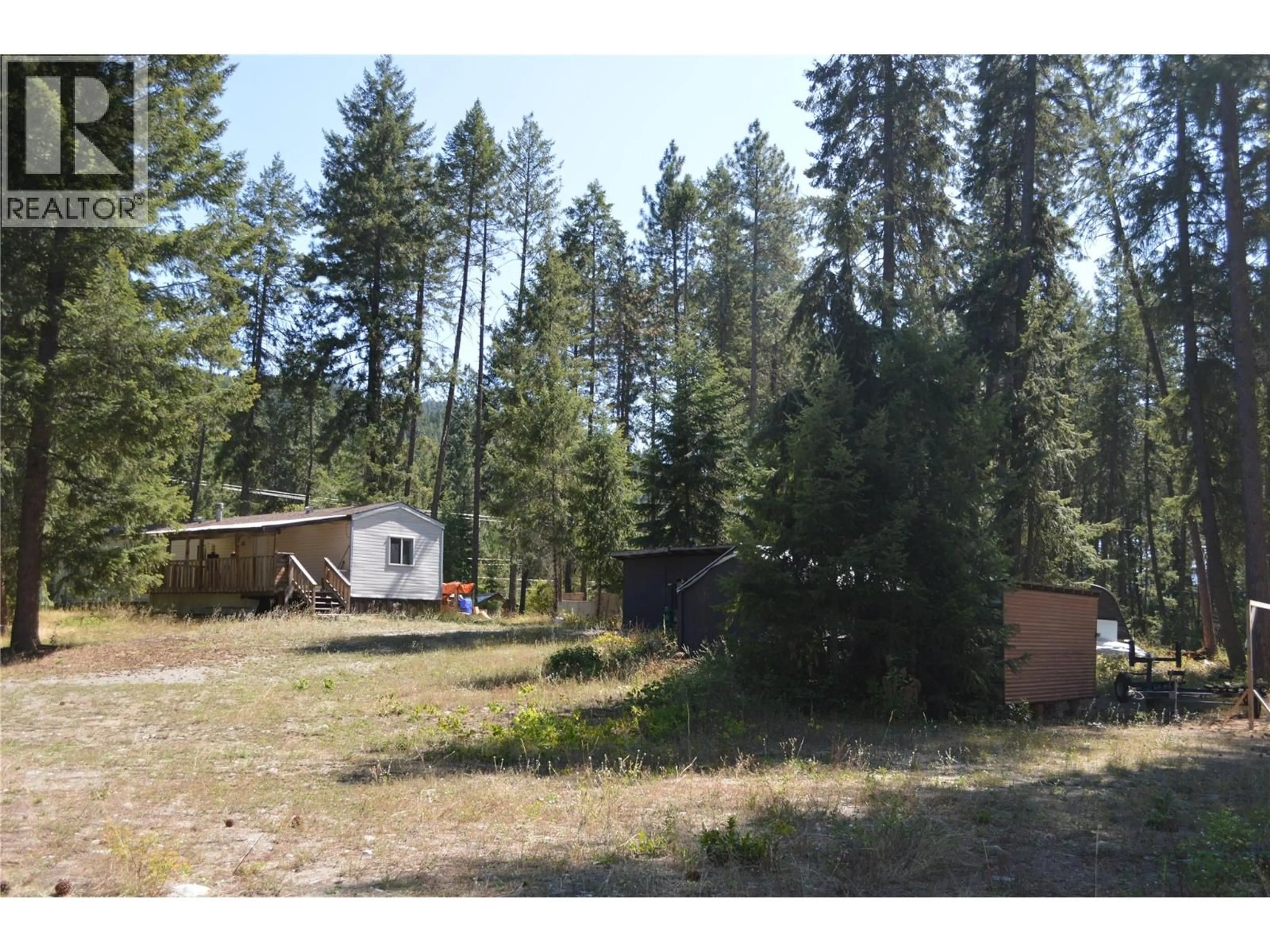 A pic from outside/outdoor area/front of a property/back of a property/a pic from drone, forest/trees view for 2021 FIFE ROAD, Christina Lake British Columbia V0H1E3