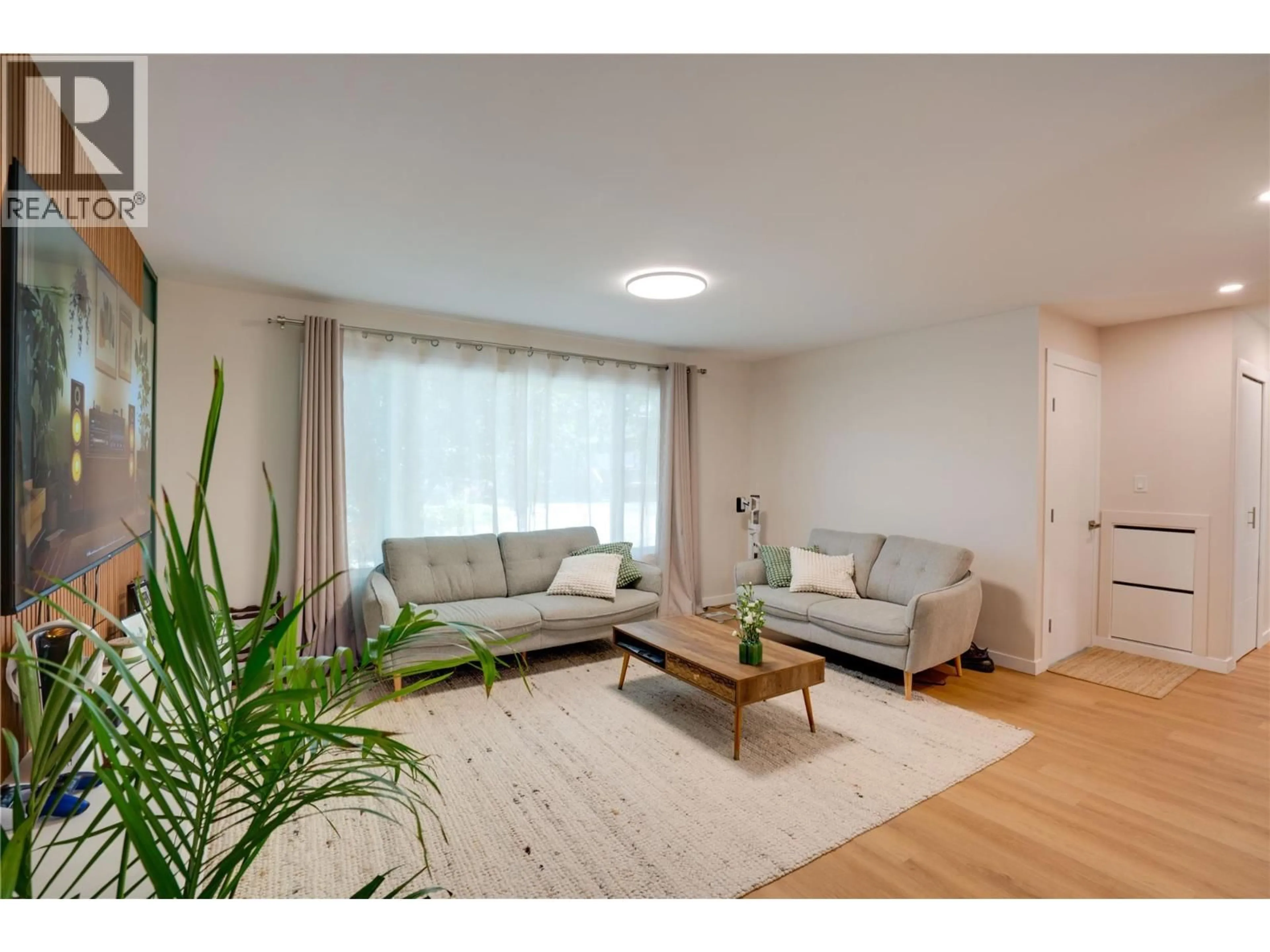 Living room with furniture, wood/laminate floor for 1802 43 STREET, Vernon British Columbia V1T6W8