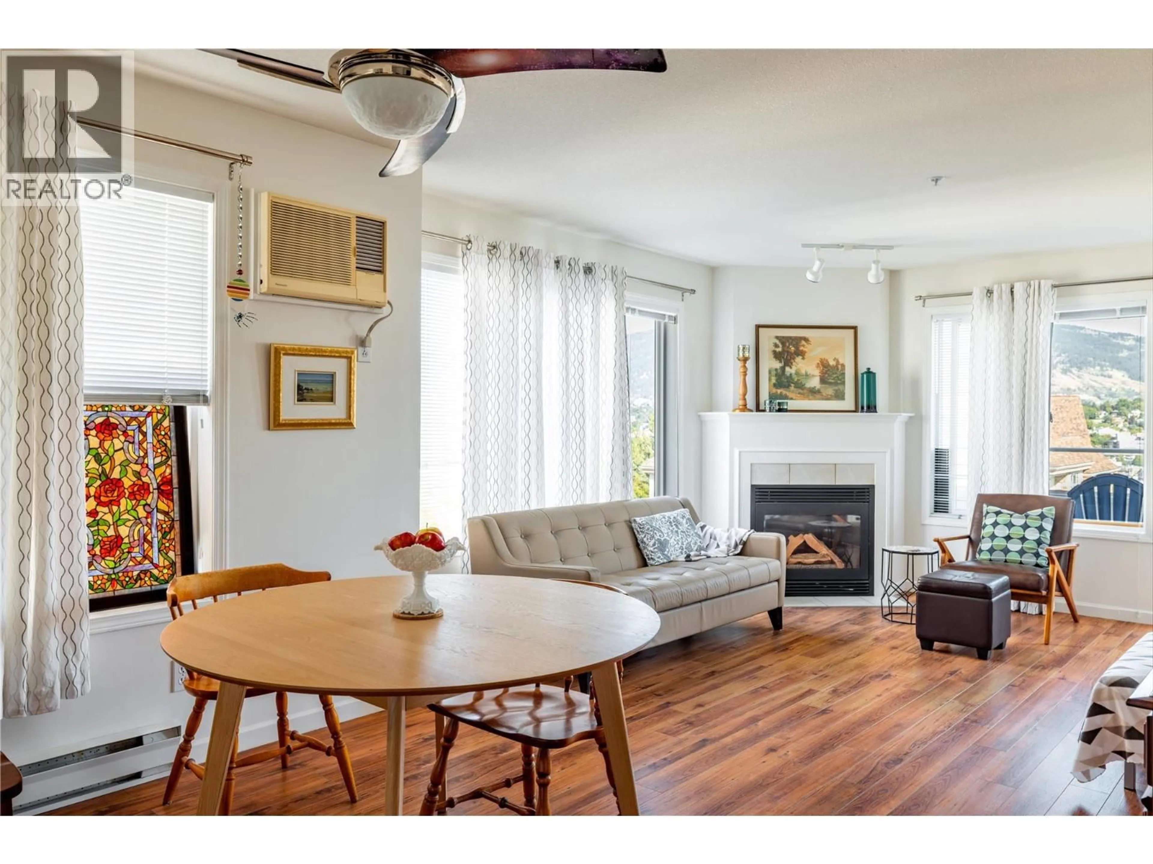 Living room with furniture, wood/laminate floor for 210 - 3320 CENTENNIAL DRIVE, Vernon British Columbia V1T9M4