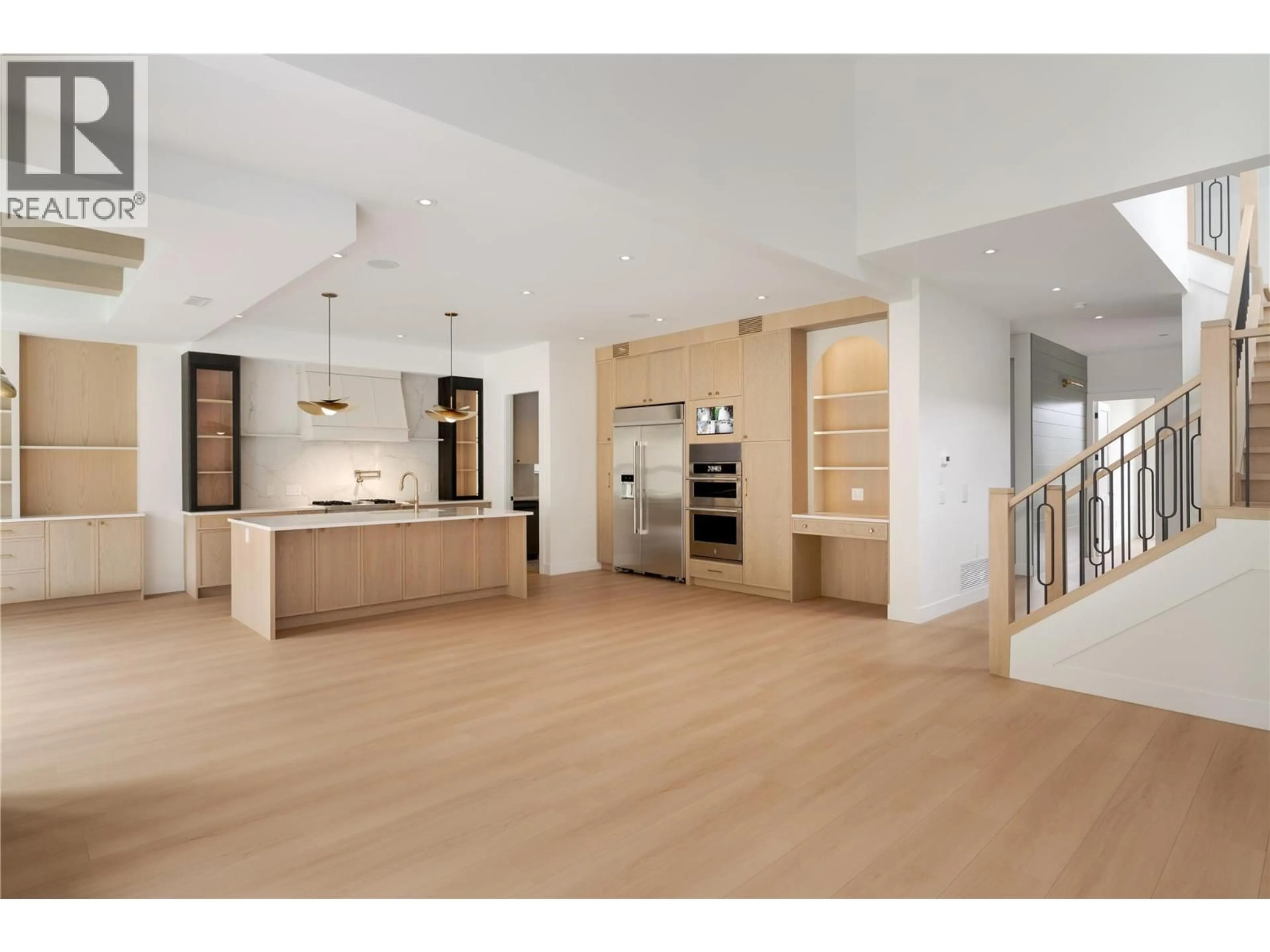 Open concept kitchen, wood/laminate floor for 1004 BULL CRESCENT, Kelowna British Columbia V1W0E6