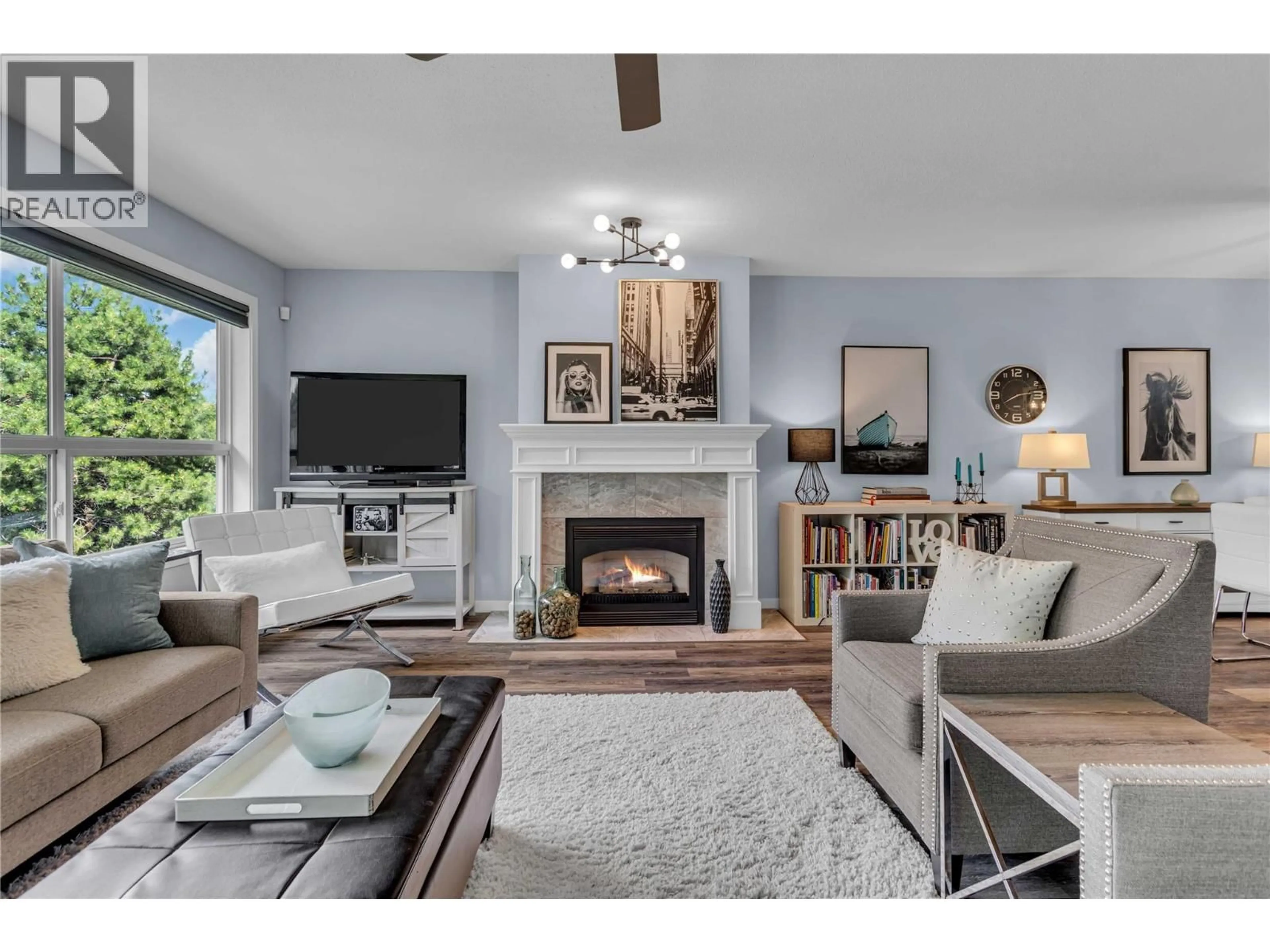 Living room with furniture, wood/laminate floor for 315 - 933 HARVEY AVENUE, Kelowna British Columbia V1Y9S1