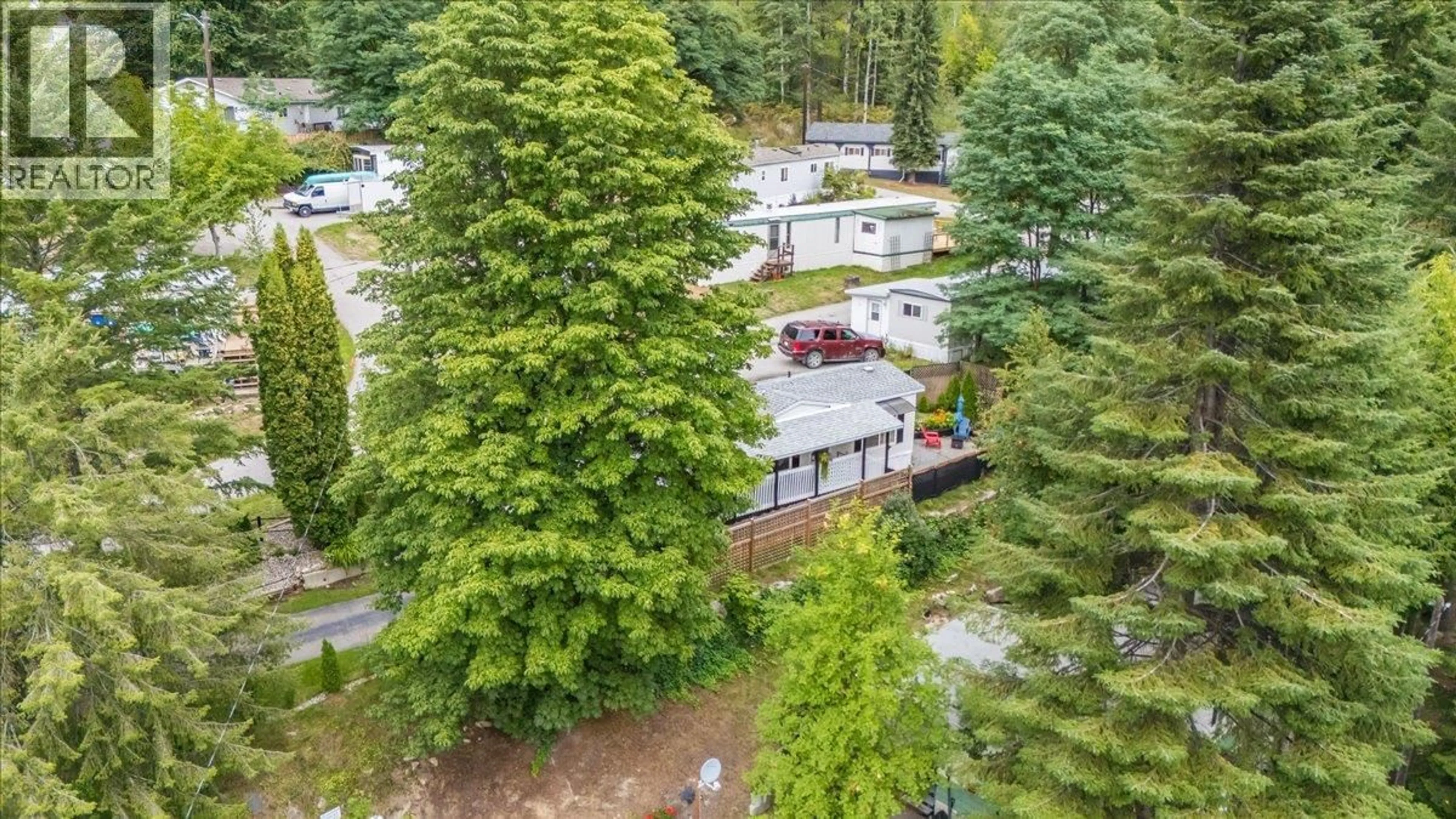 A pic from outside/outdoor area/front of a property/back of a property/a pic from drone, forest/trees view for 32 - 739 HIGHWAY 3A HIGHWAY, Nelson British Columbia V1L6M4