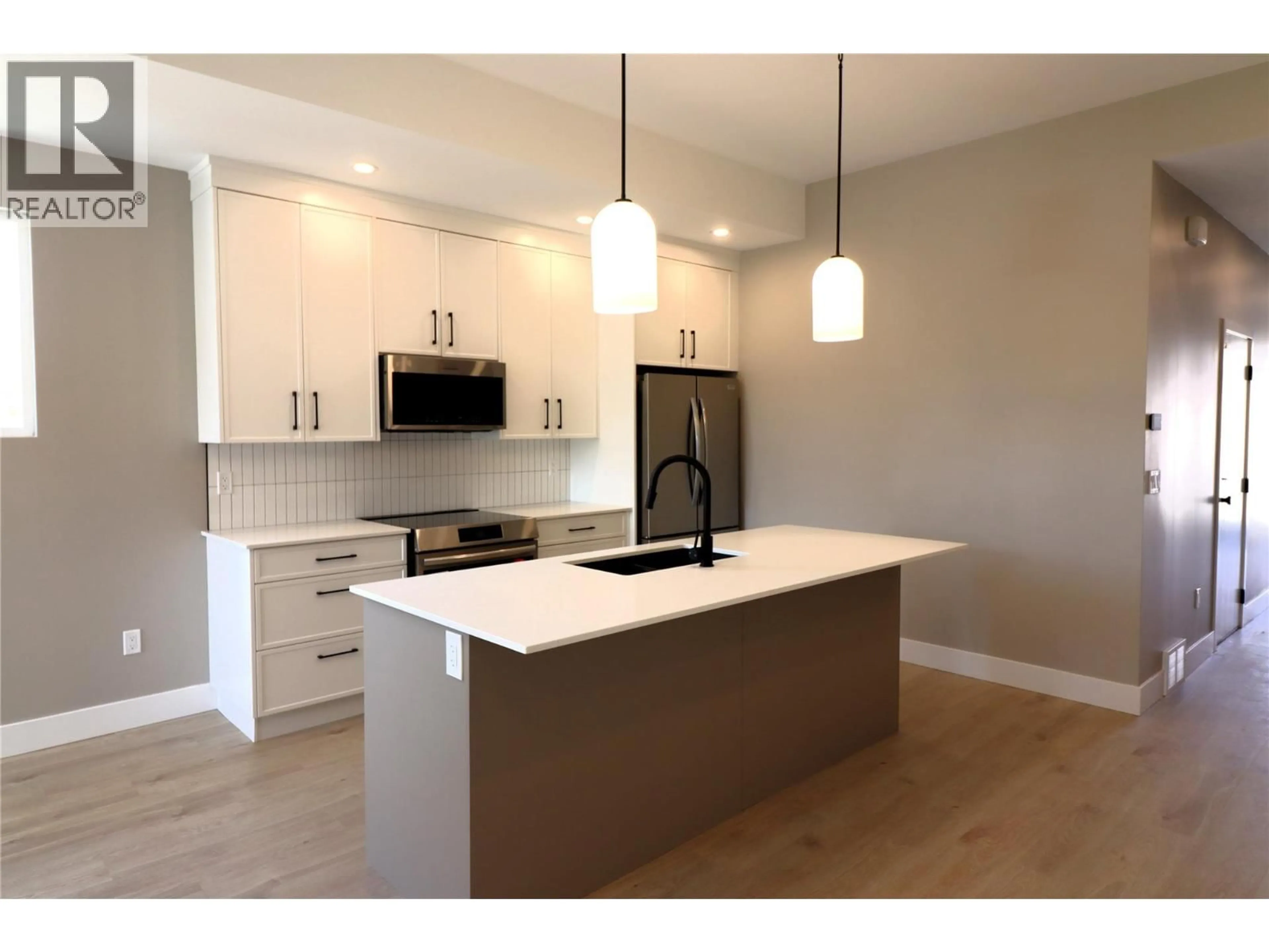 Open concept kitchen, wood/laminate floor for 161 CHESTNUT AVENUE, Kamloops British Columbia V2B1L3