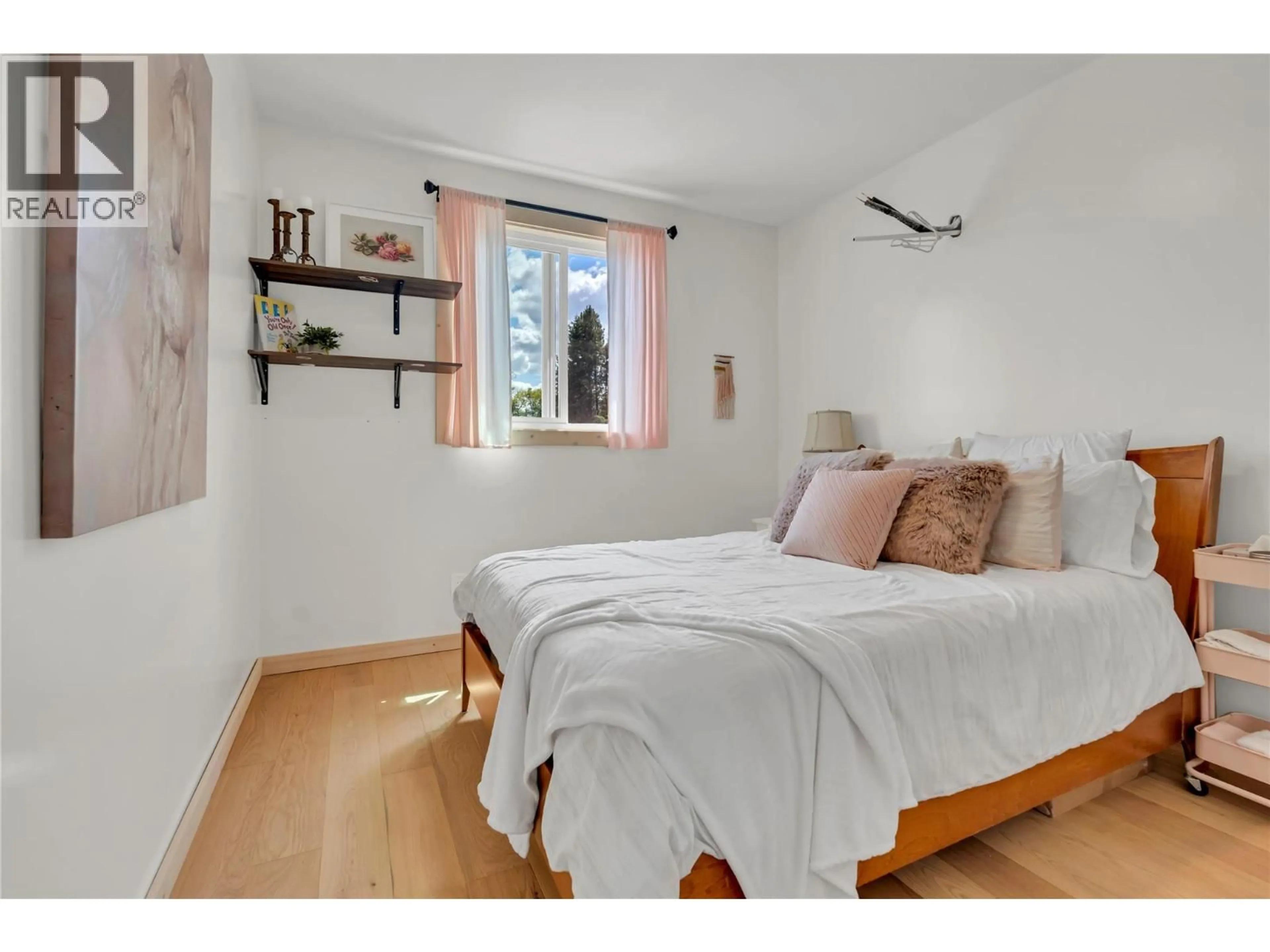 Bedroom with bed, wood/laminate floor for 6074 JACKSON CRESCENT, Peachland British Columbia V0H1X4