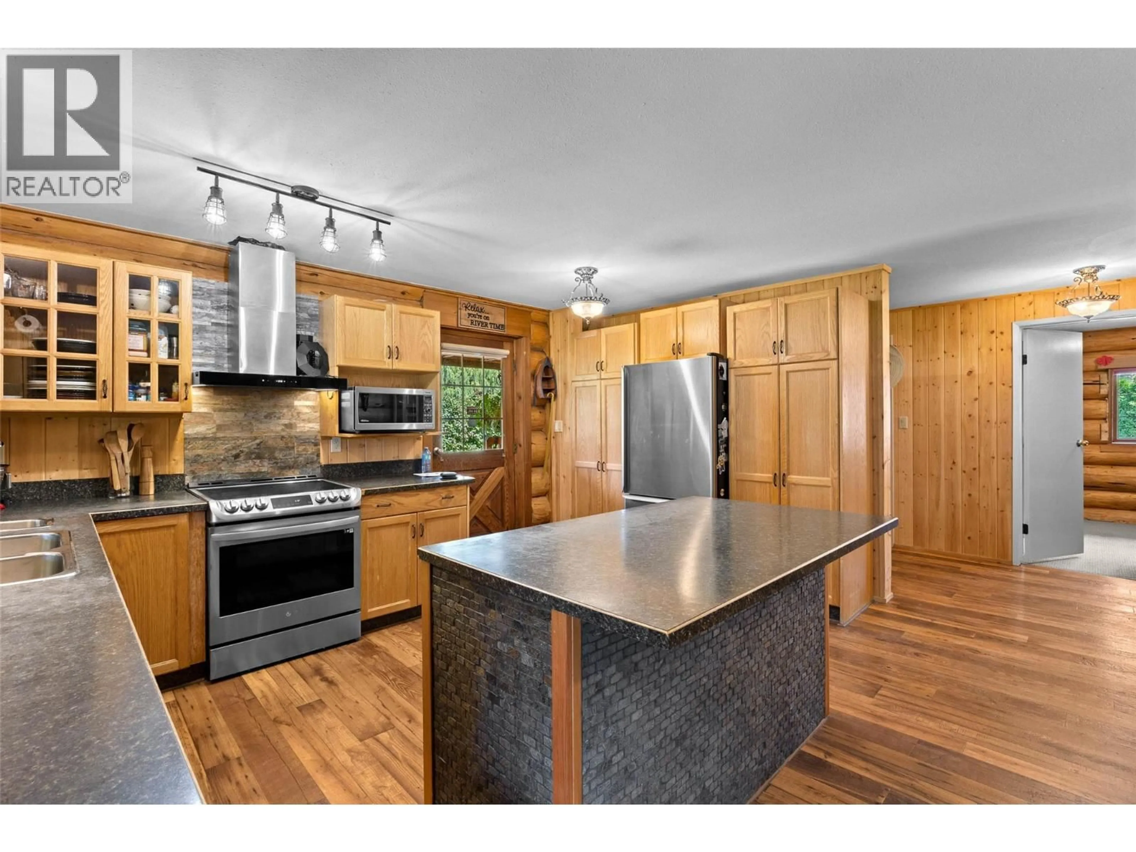 Open concept kitchen, wood/laminate floor for 311 HOLLYWOOD CRESCENT, Lillooet British Columbia V0K1V0