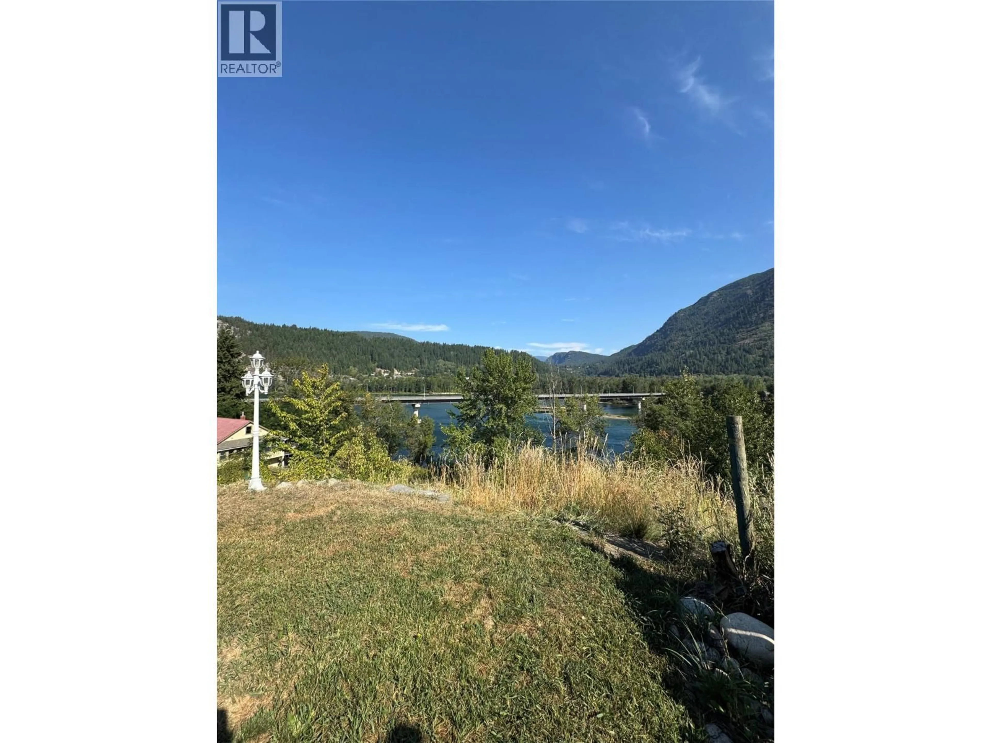 A pic from outside/outdoor area/front of a property/back of a property/a pic from drone, water/lake/river/ocean view for 1 - 1225 1ST STREET, Castlegar British Columbia V1N1A1