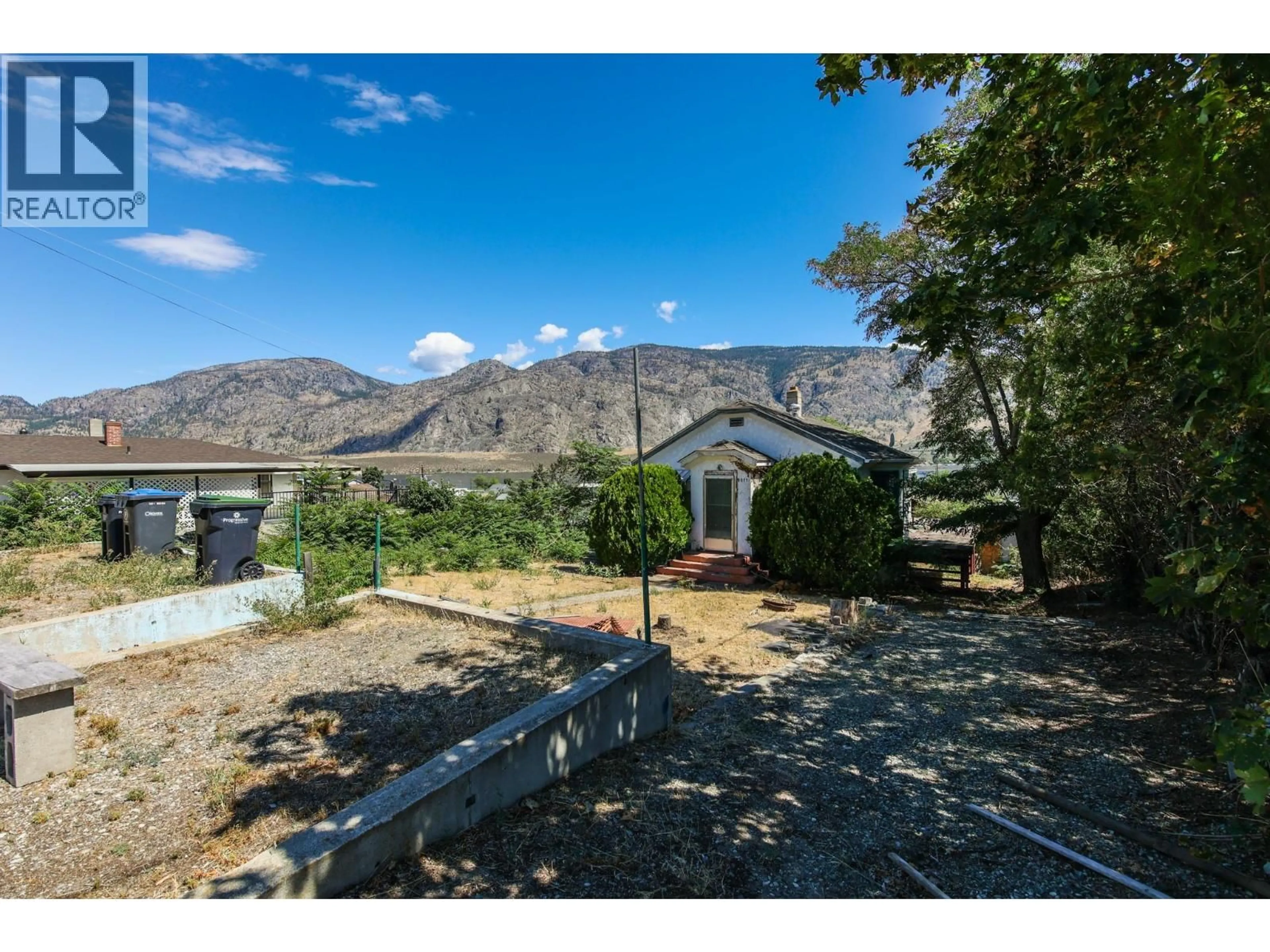 A pic from outside/outdoor area/front of a property/back of a property/a pic from drone, mountain view for 8011 87TH STREET, Osoyoos British Columbia V0H1V0