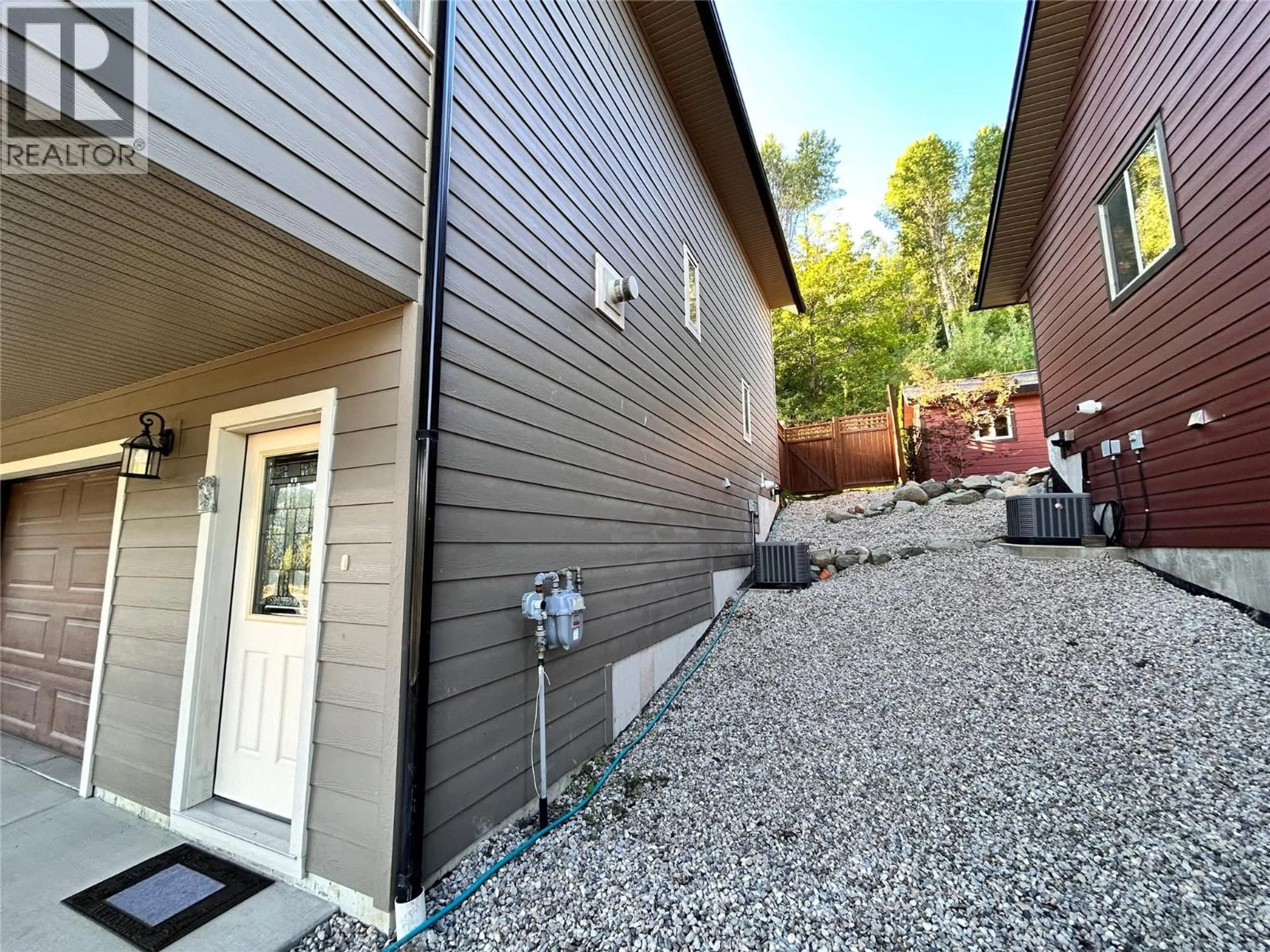 Home with vinyl exterior material, street for 948 REDSTONE DRIVE, Rossland British Columbia V0G1Y0