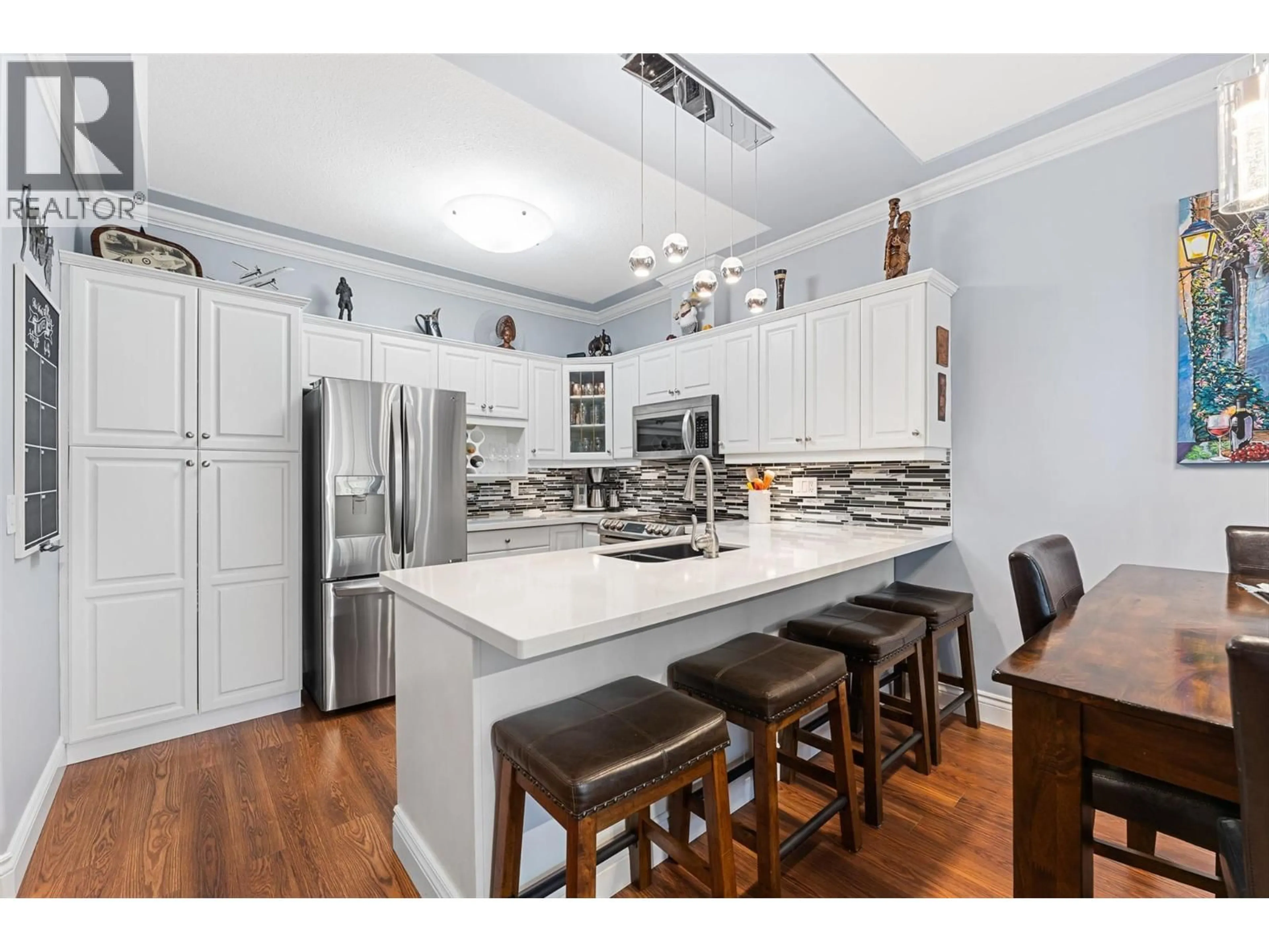 Open concept kitchen, wood/laminate floor for 210 - 1152 LANFRANCO ROAD, Kelowna British Columbia V1W3W5