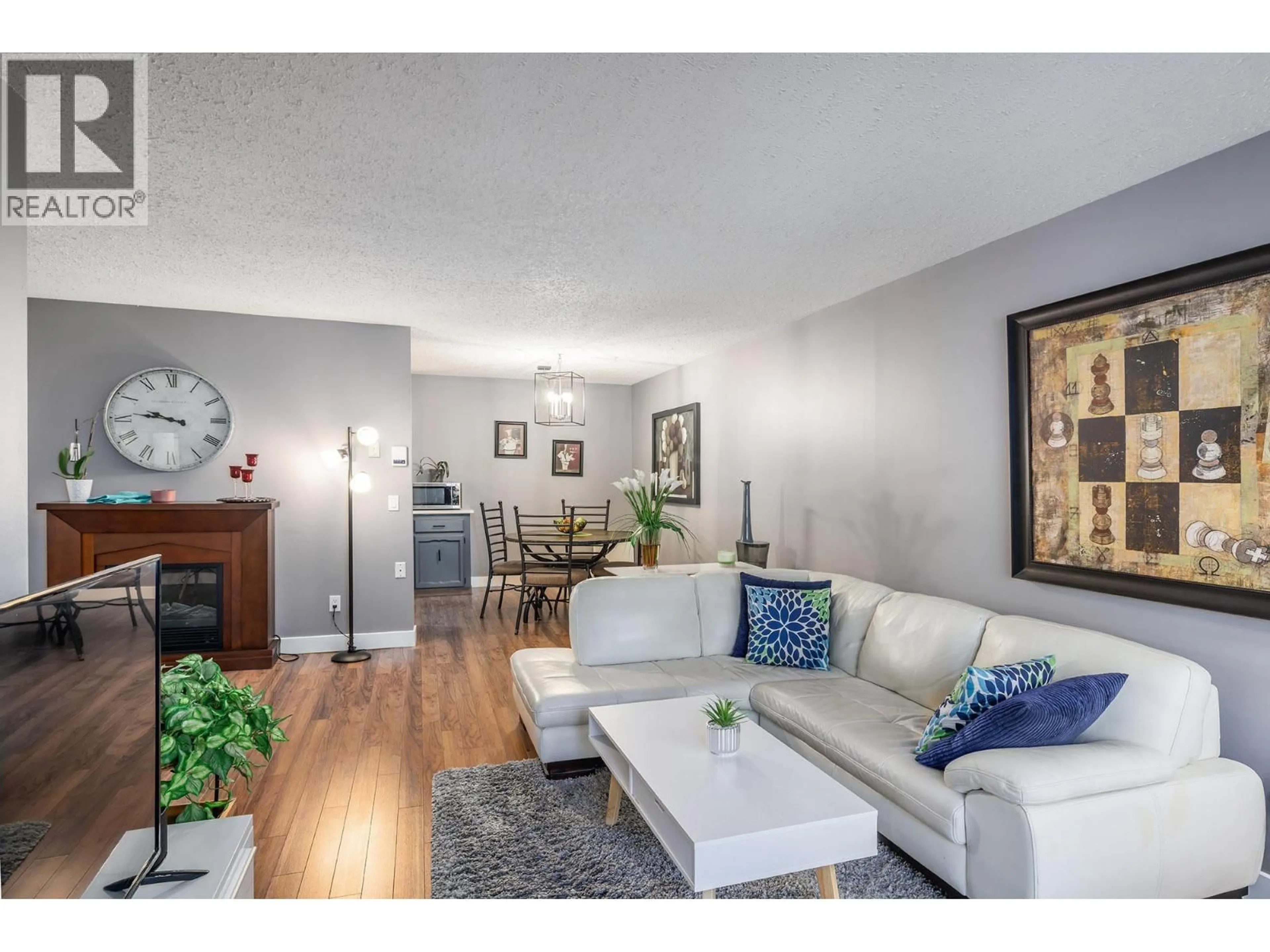 Living room with furniture, wood/laminate floor for 307 - 555 ROWCLIFFE AVENUE, Kelowna British Columbia V1Y5Y8