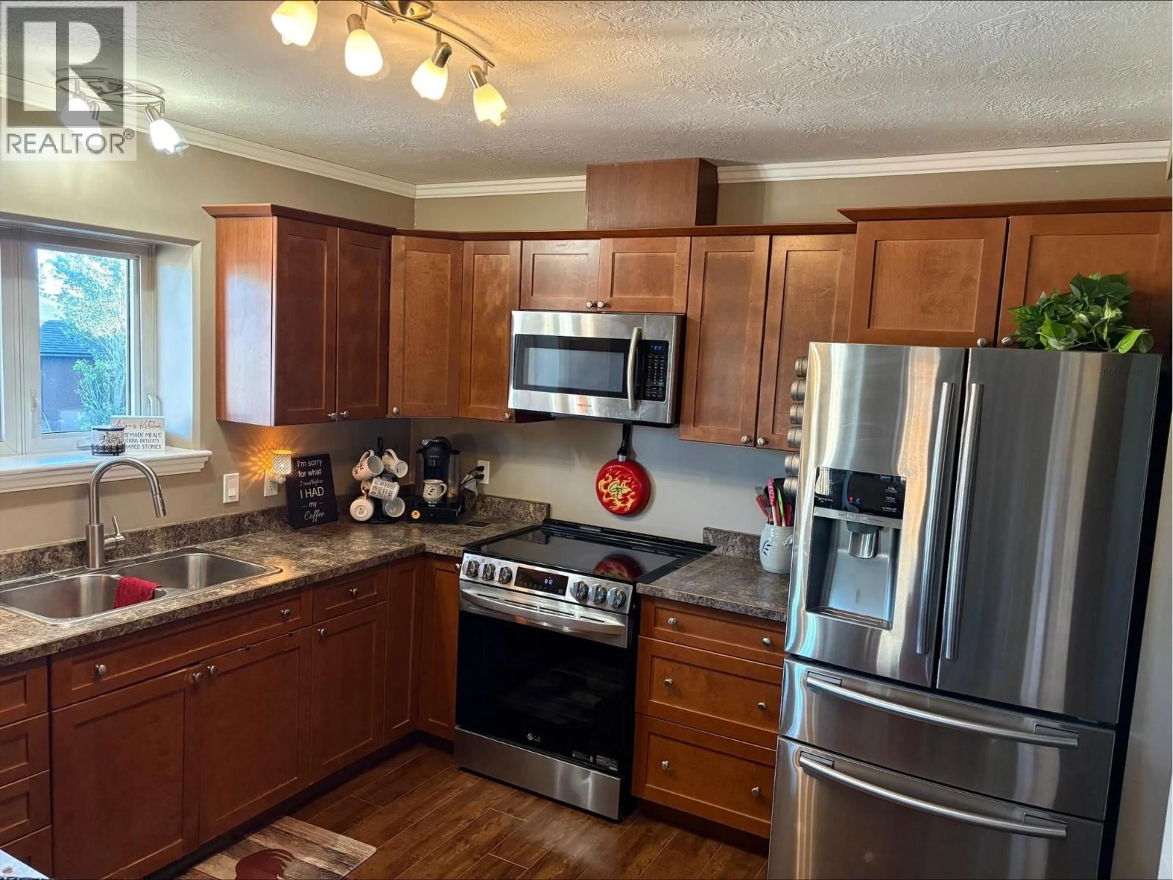 Open concept kitchen, wood/laminate floor for 4808 46 AVENUE, Pouce Coupe British Columbia V0C2C0
