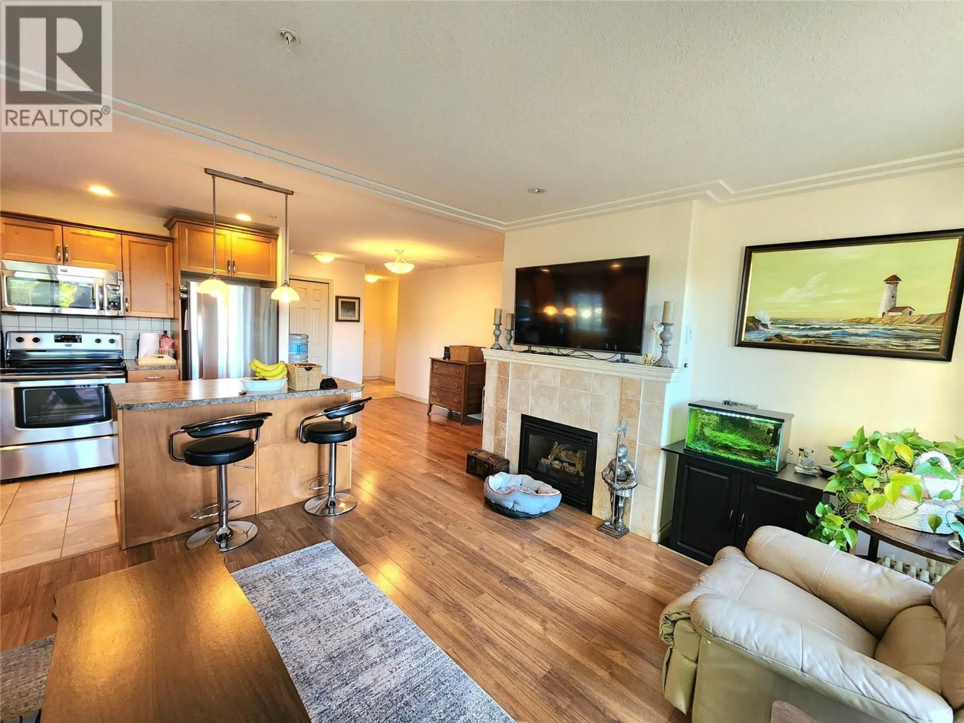 Living room with furniture, wood/laminate floor for 302 - 2125 ATKINSON STREET, Penticton British Columbia V2A9E6