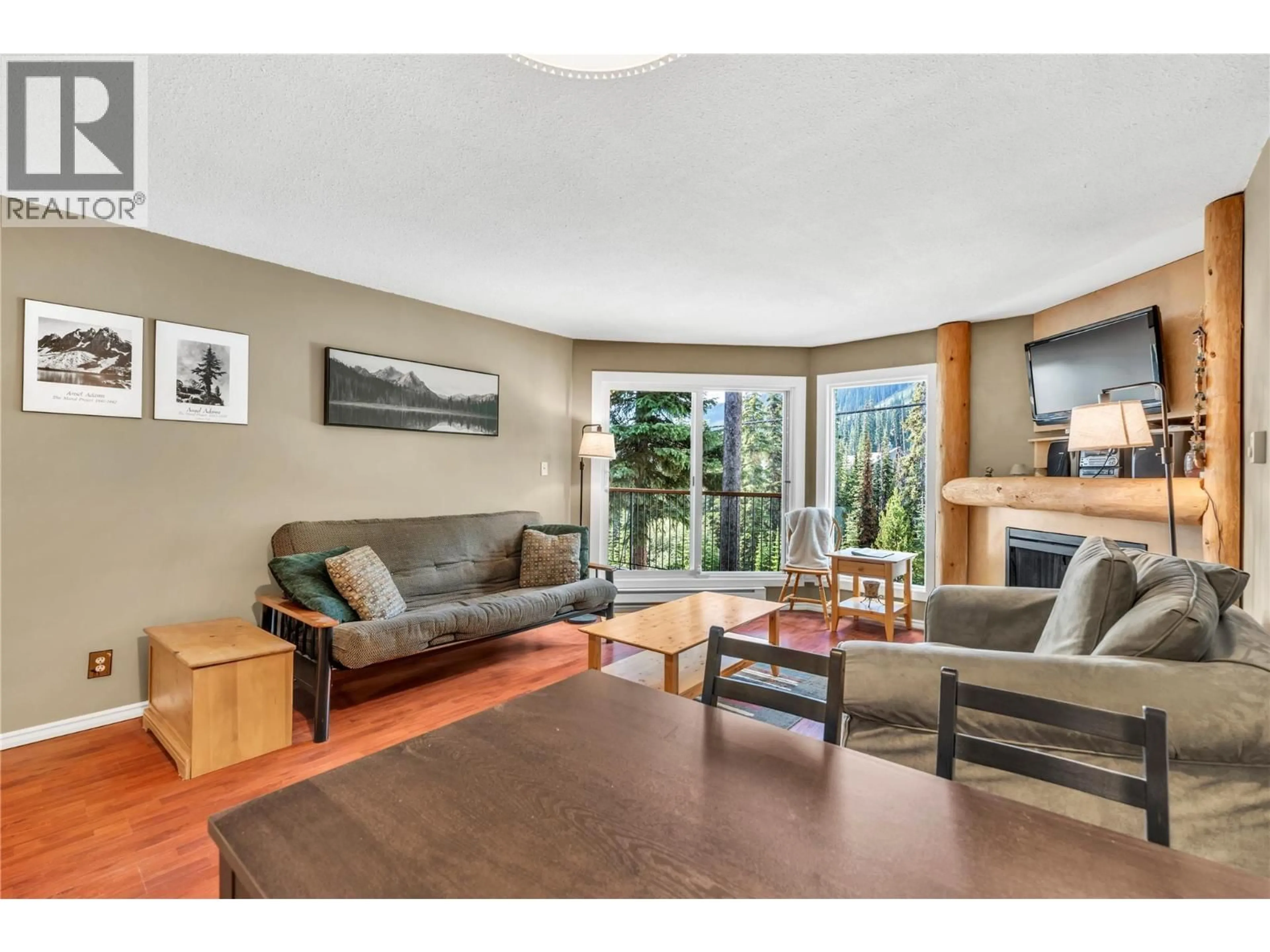 Living room with furniture, wood/laminate floor for 206 - 1191 APEX MOUNTAIN ROAD, Penticton British Columbia V2A0E2