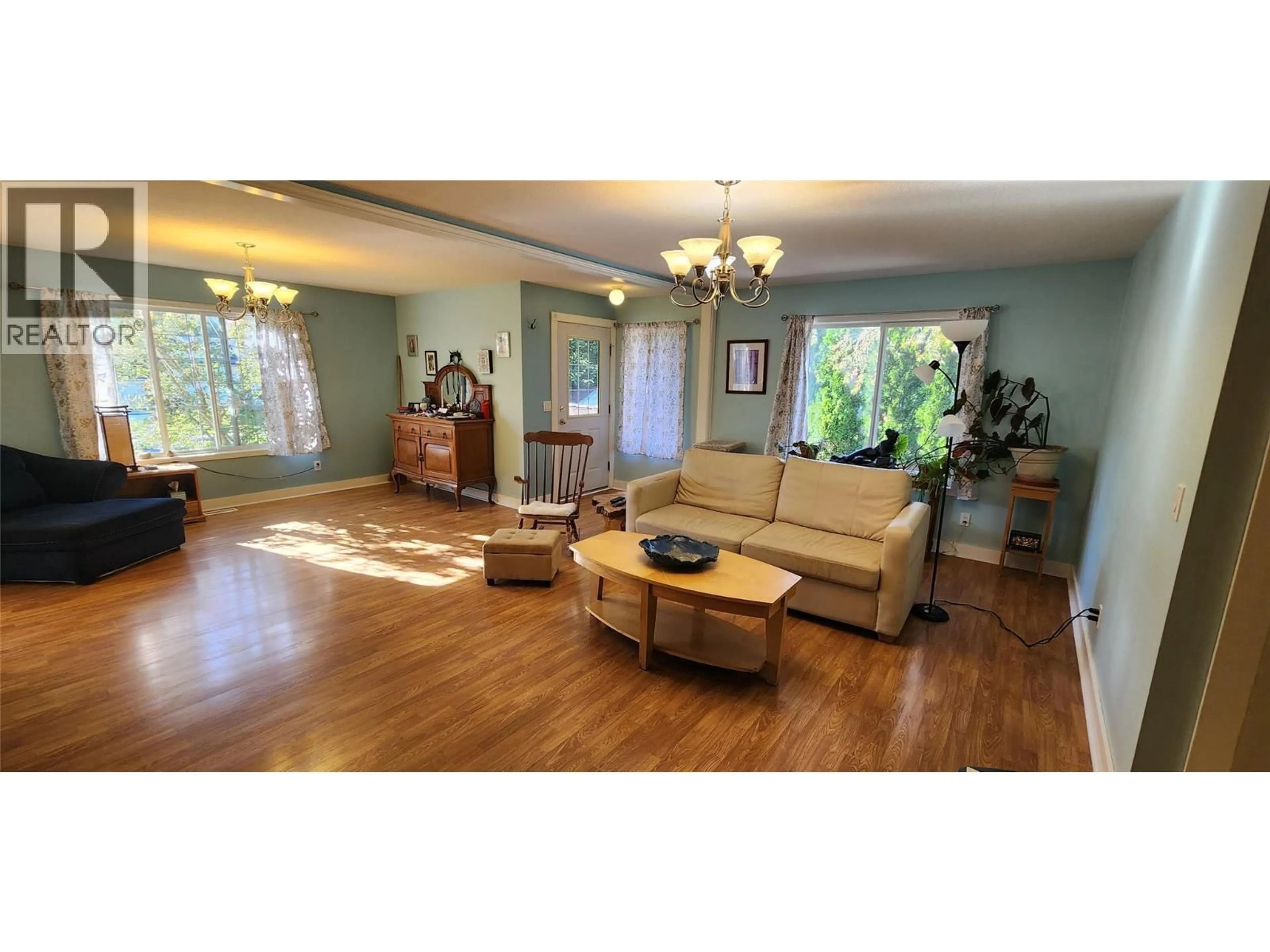 Living room with furniture, wood/laminate floor for 7766 18TH STREET, Grand Forks British Columbia V0H1H2