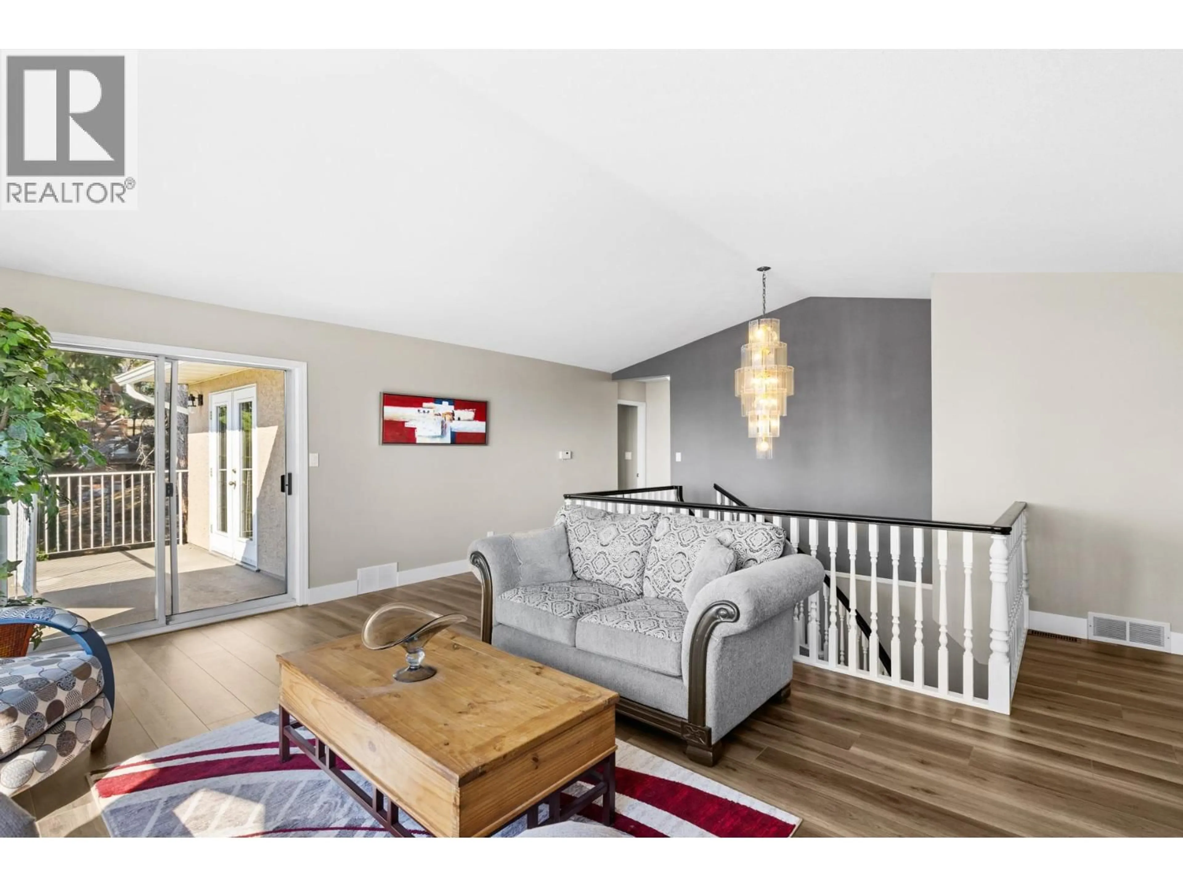 Living room with furniture, wood/laminate floor for 1175 TOOVEY ROAD, Kelowna British Columbia V1X6R3