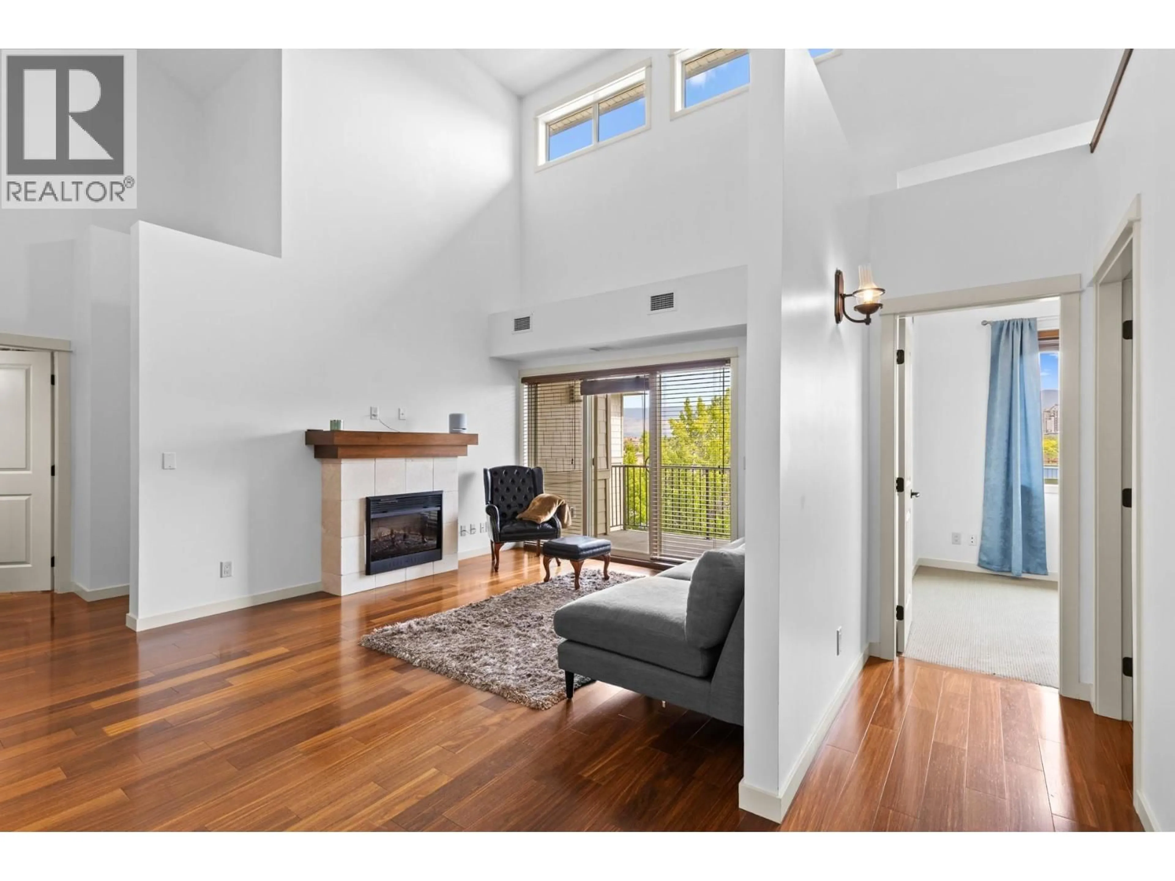 Living room with furniture, wood/laminate floor for 413 - 2142 VASILE ROAD, Kelowna British Columbia V1Y6H5