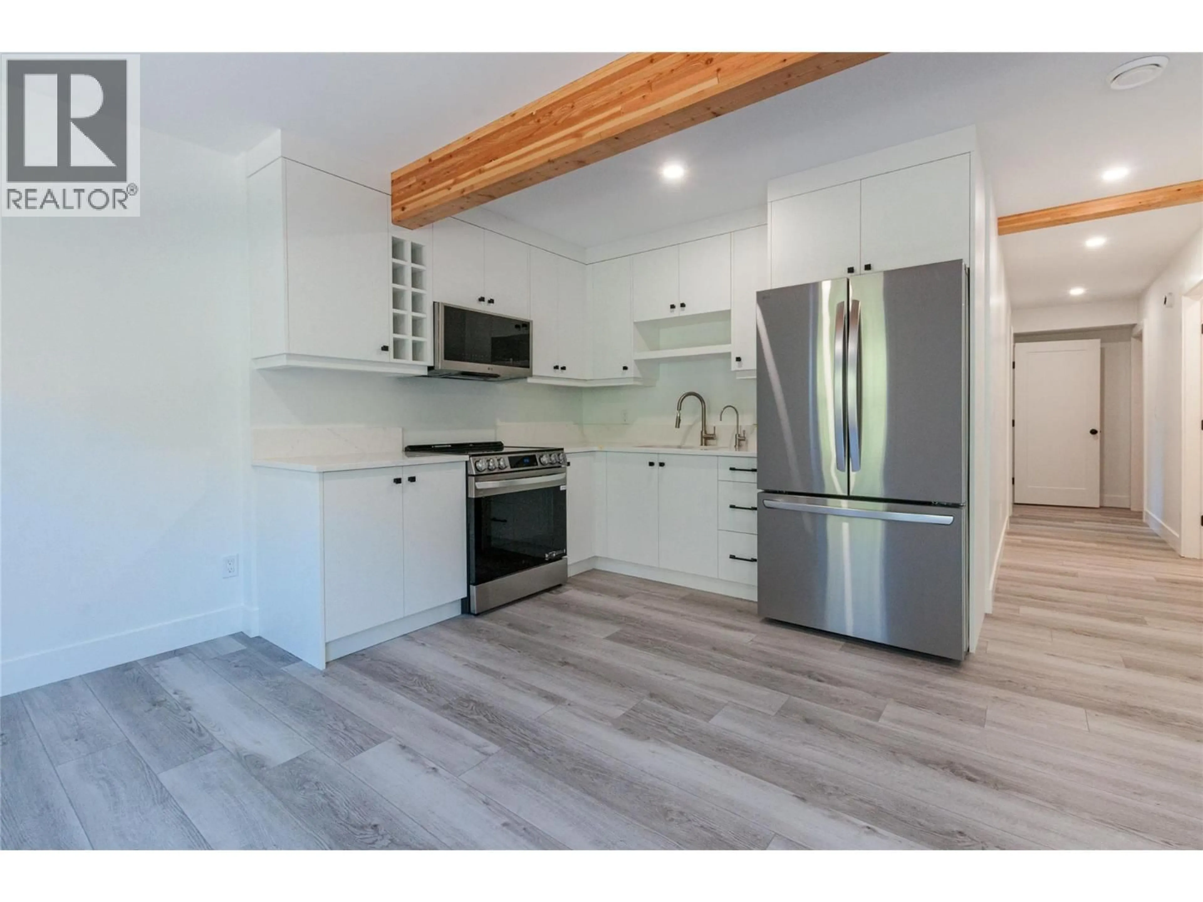 Open concept kitchen, wood/laminate floor for 645 GRAND ORO ROAD, Kaleden British Columbia V0H1K0