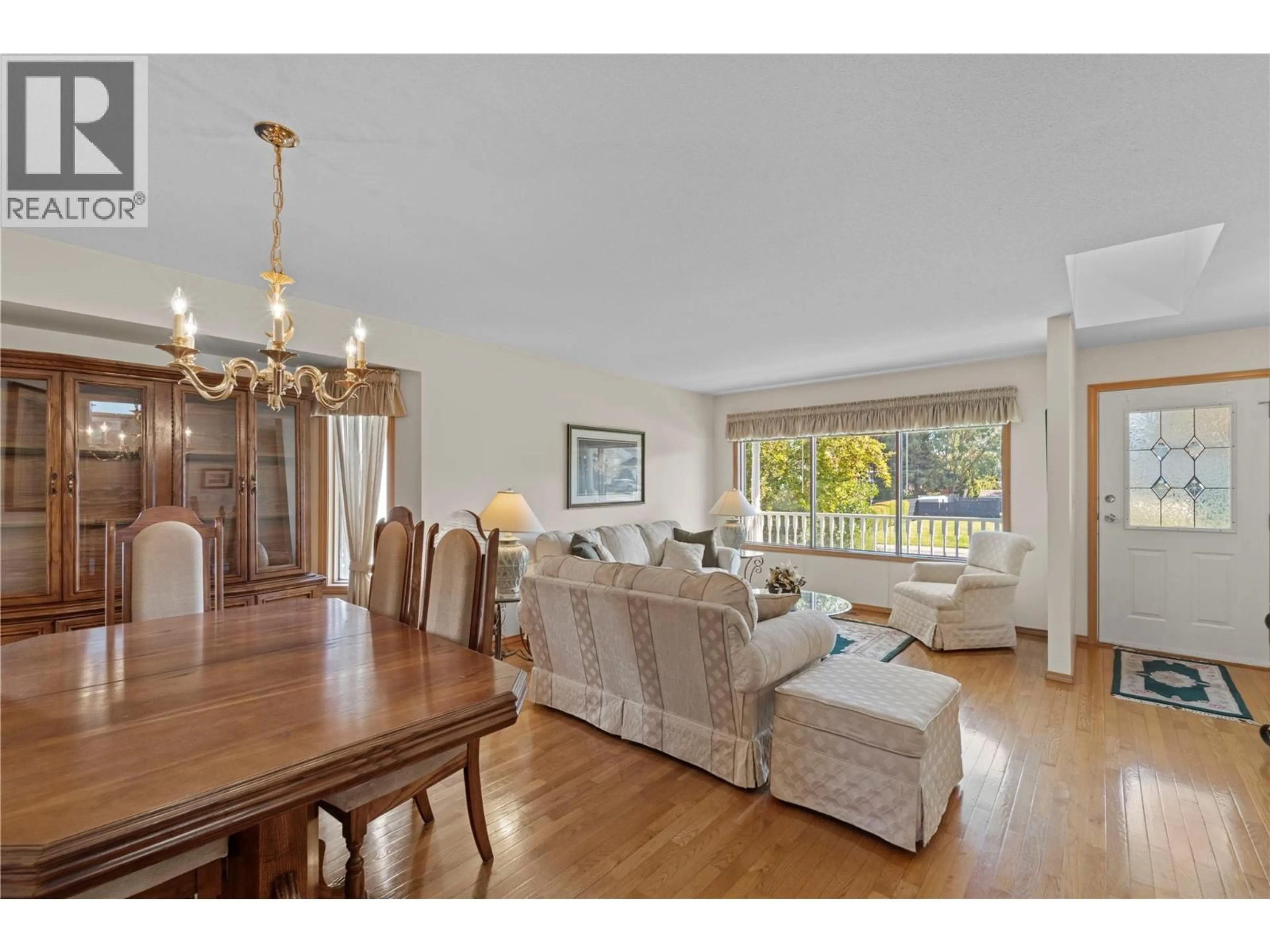 Living room with furniture, wood/laminate floor for 2022 TREMERTON DRIVE, Kamloops British Columbia V2E2L1