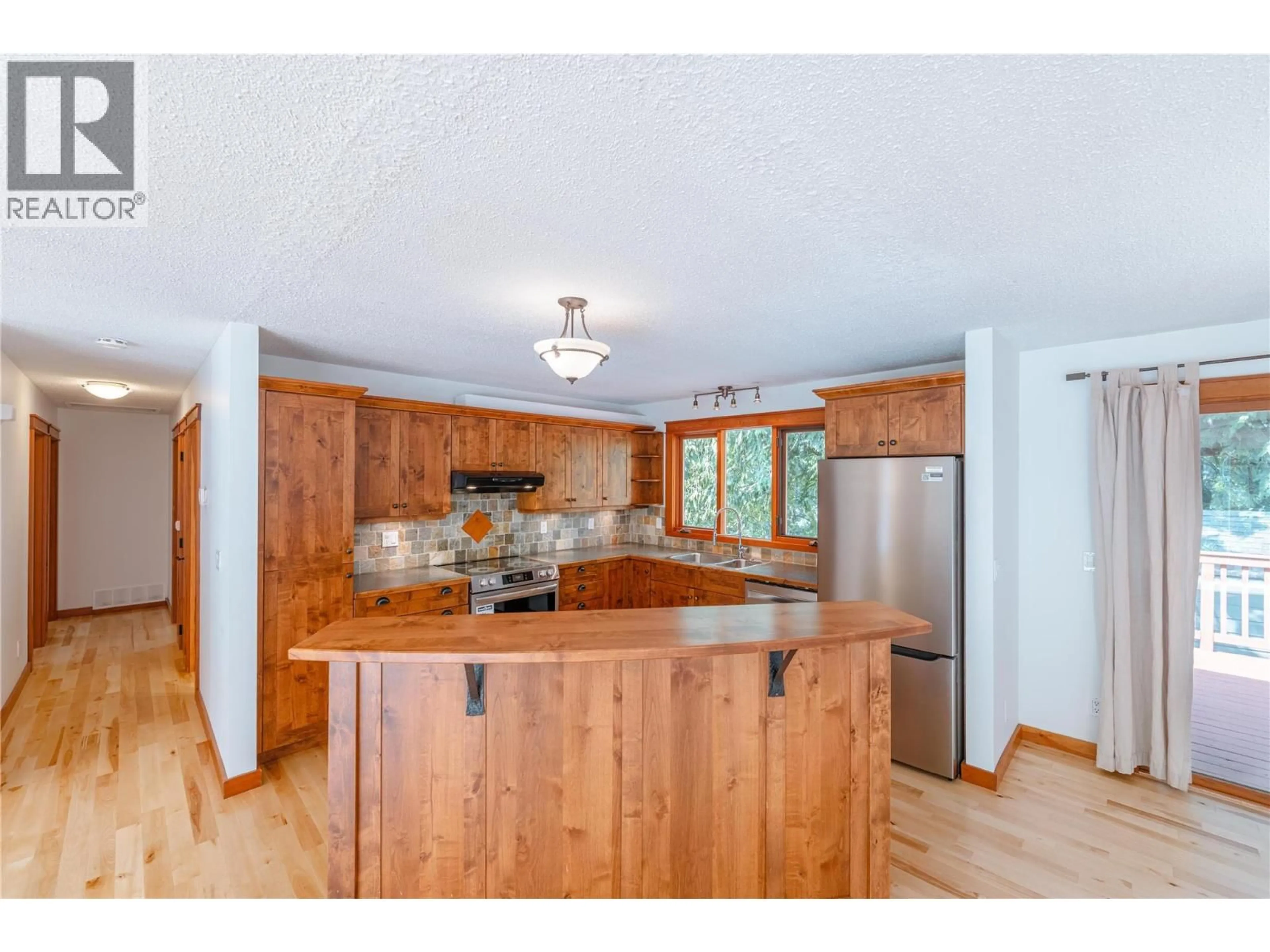 Open concept kitchen, wood/laminate floor for 387 PEARKES DRIVE, Revelstoke British Columbia V0E2S0