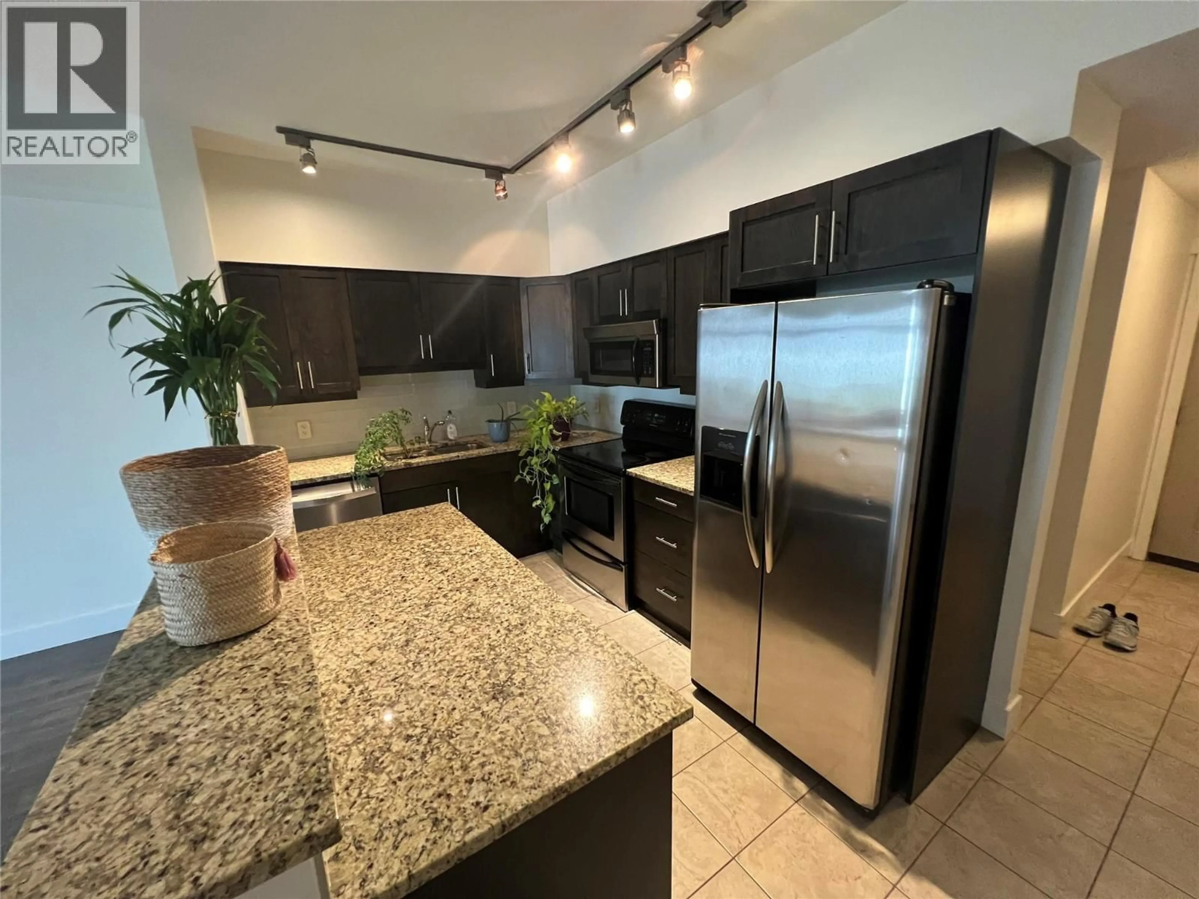 Open concept kitchen, ceramic/tile floor for 106 - 5570 BROADWATER ROAD, Castlegar British Columbia V1N0A1