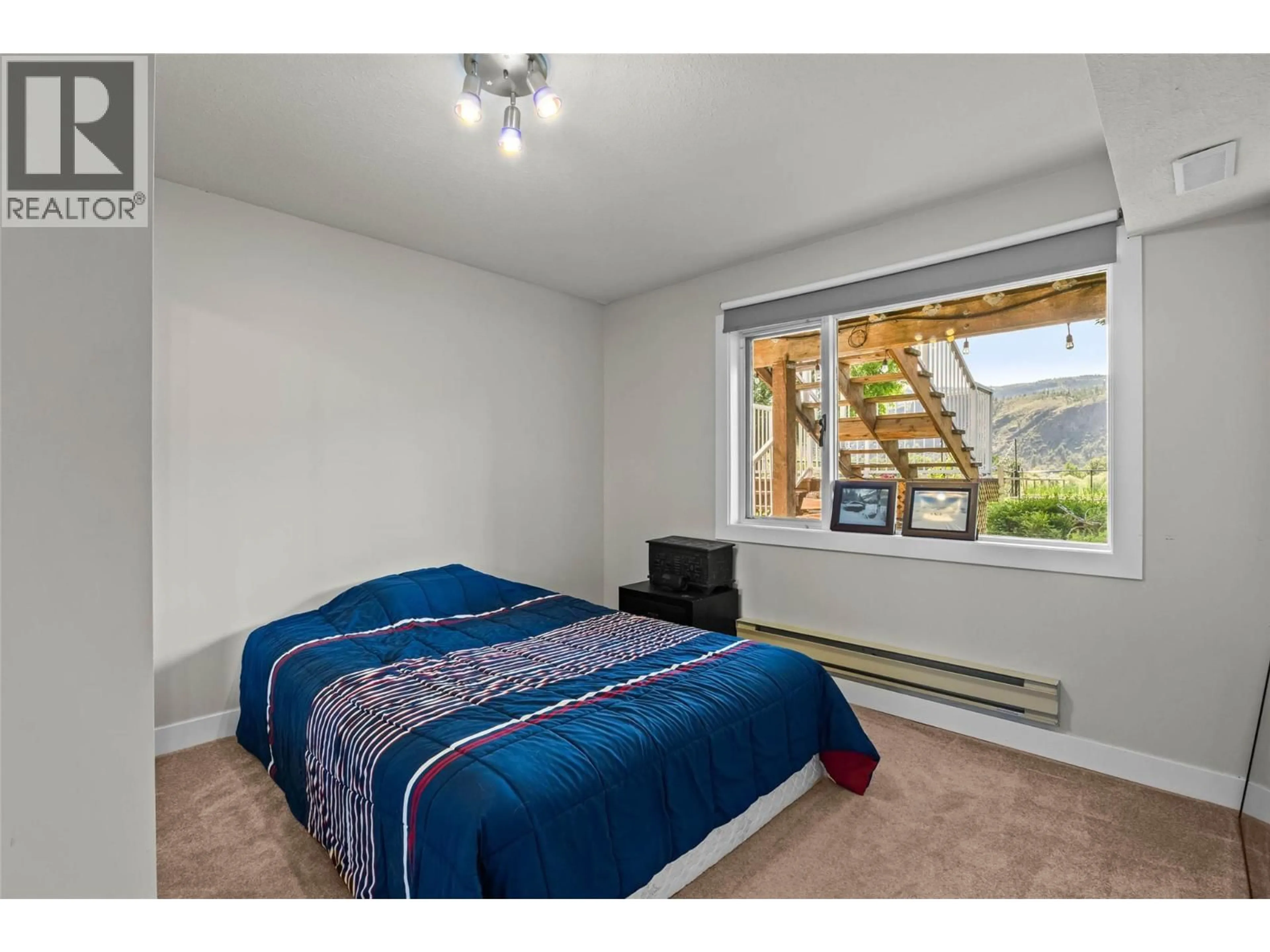 Bedroom with bed, wood/laminate floor for 4061 DAVIE ROAD, Kamloops British Columbia V2H1K8