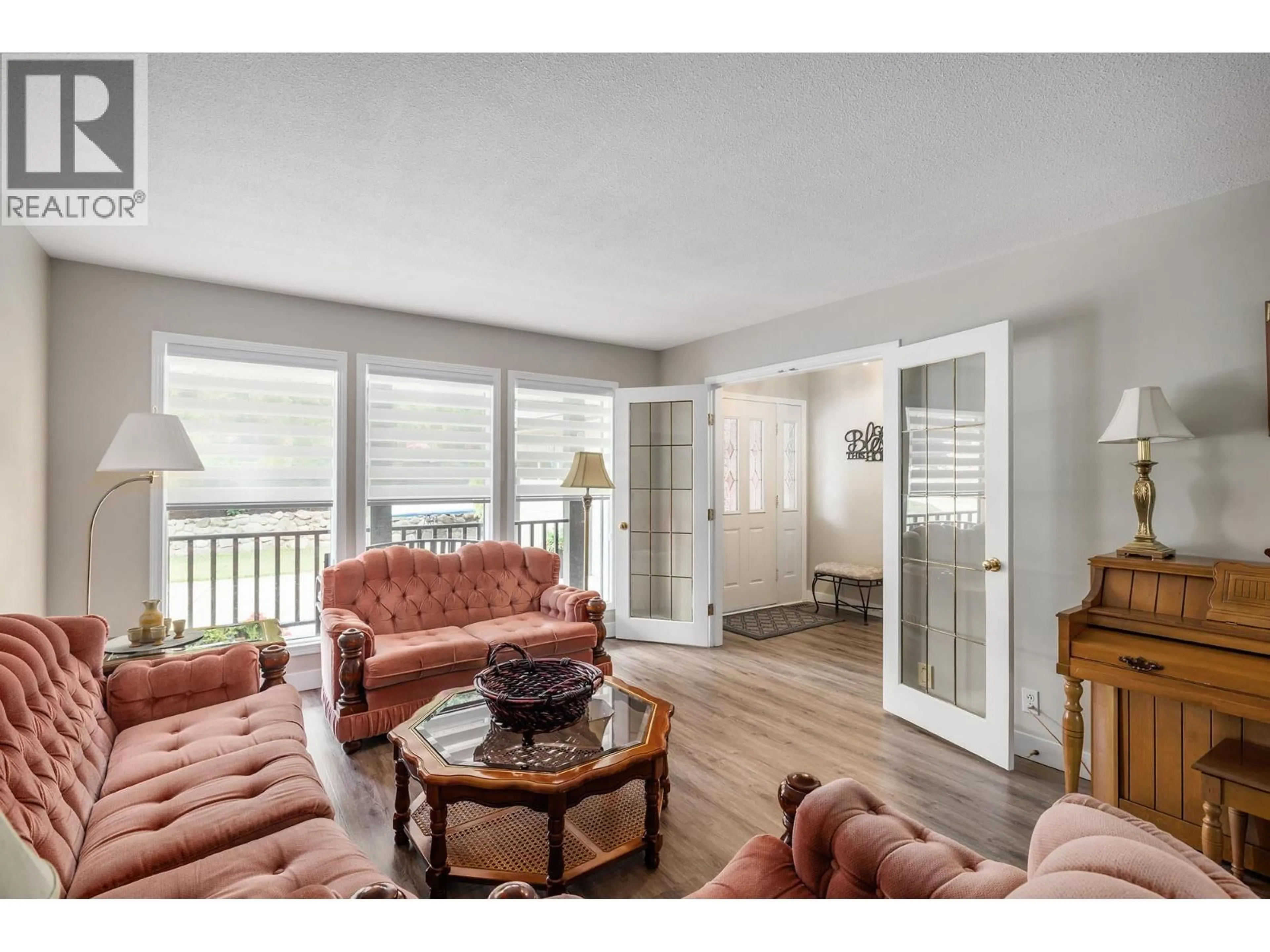 Living room with furniture, wood/laminate floor for 3195 SAGEBRUSH COURT, West Kelowna British Columbia V4T2G6