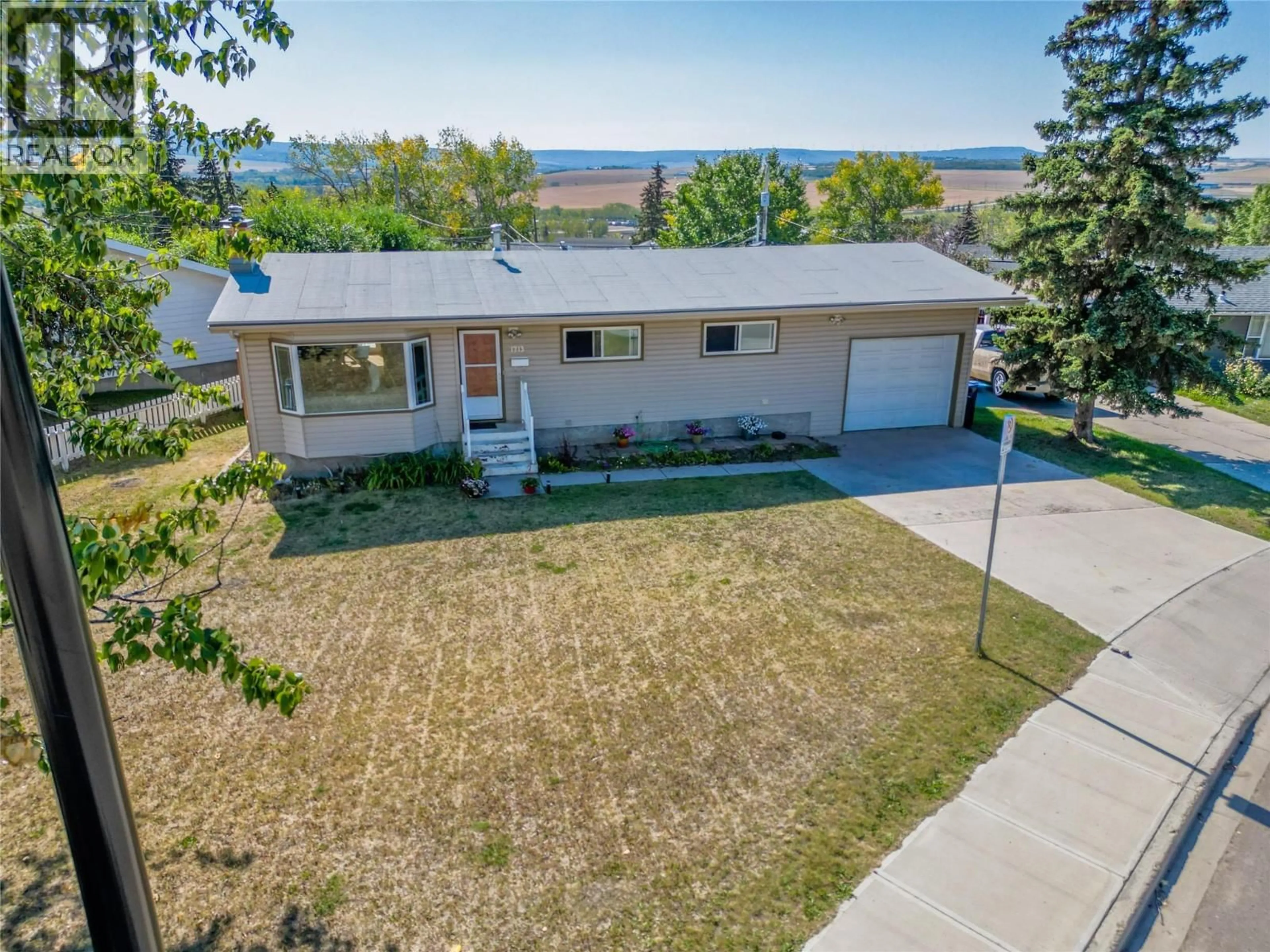 A pic from outside/outdoor area/front of a property/back of a property/a pic from drone, street for 1713 92 AVENUE, Dawson Creek British Columbia V1G1C6