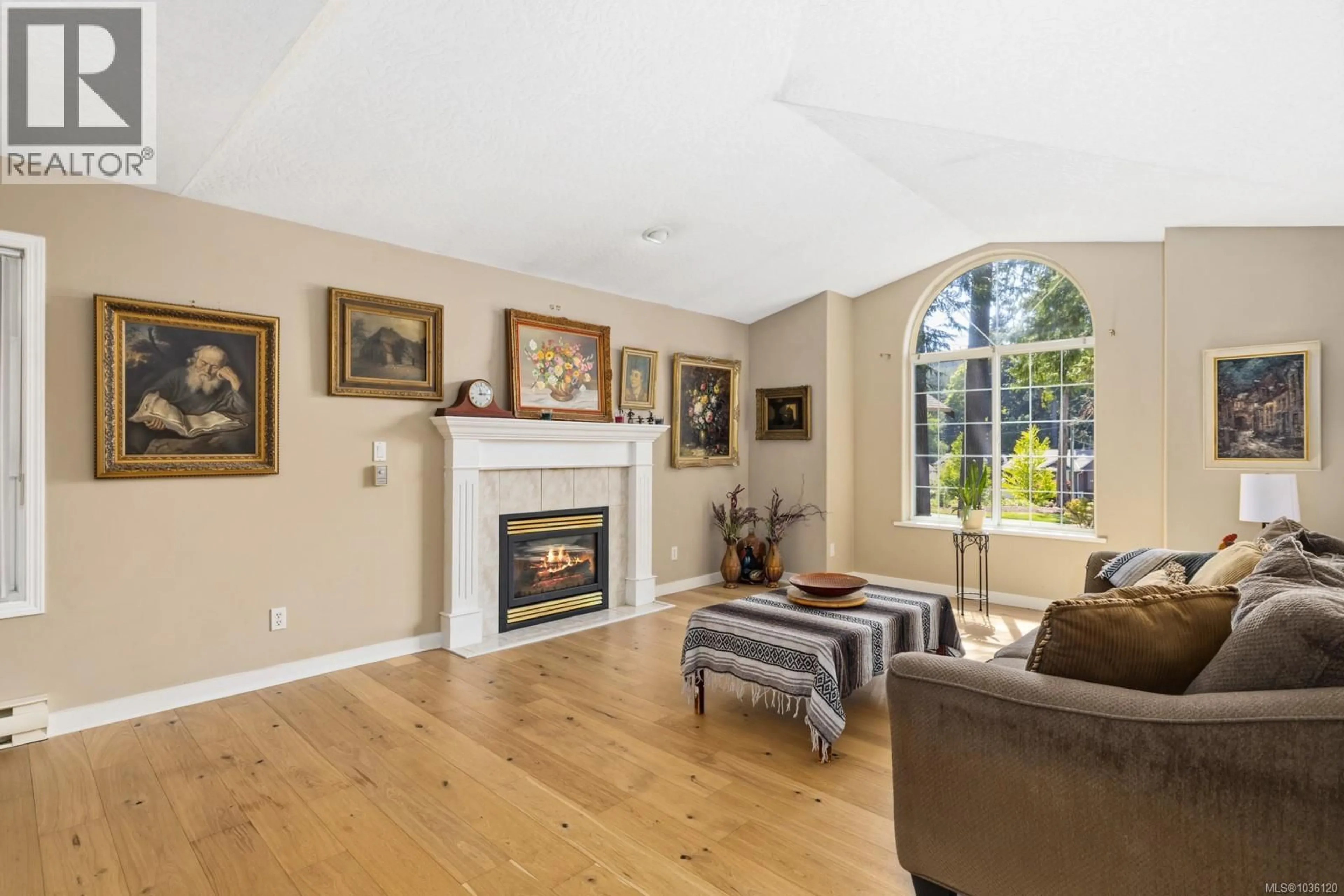 Living room with furniture, wood/laminate floor for 2497 CAYMAN PLACE, Mill Bay British Columbia V0R2P1