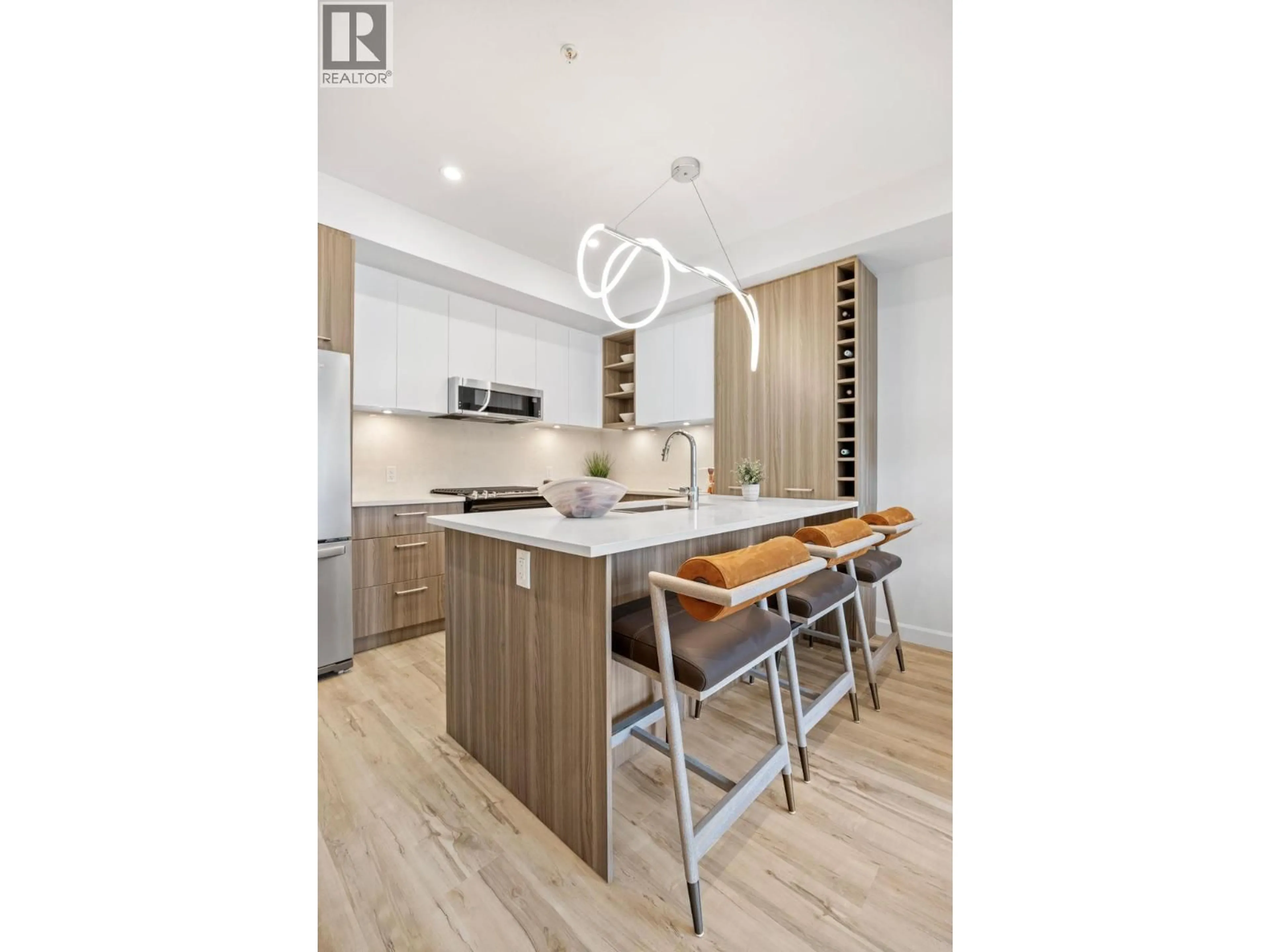 Open concept kitchen, wood/laminate floor for 213 - 630 BOYNTON PLACE, Kelowna British Columbia V1W3S9