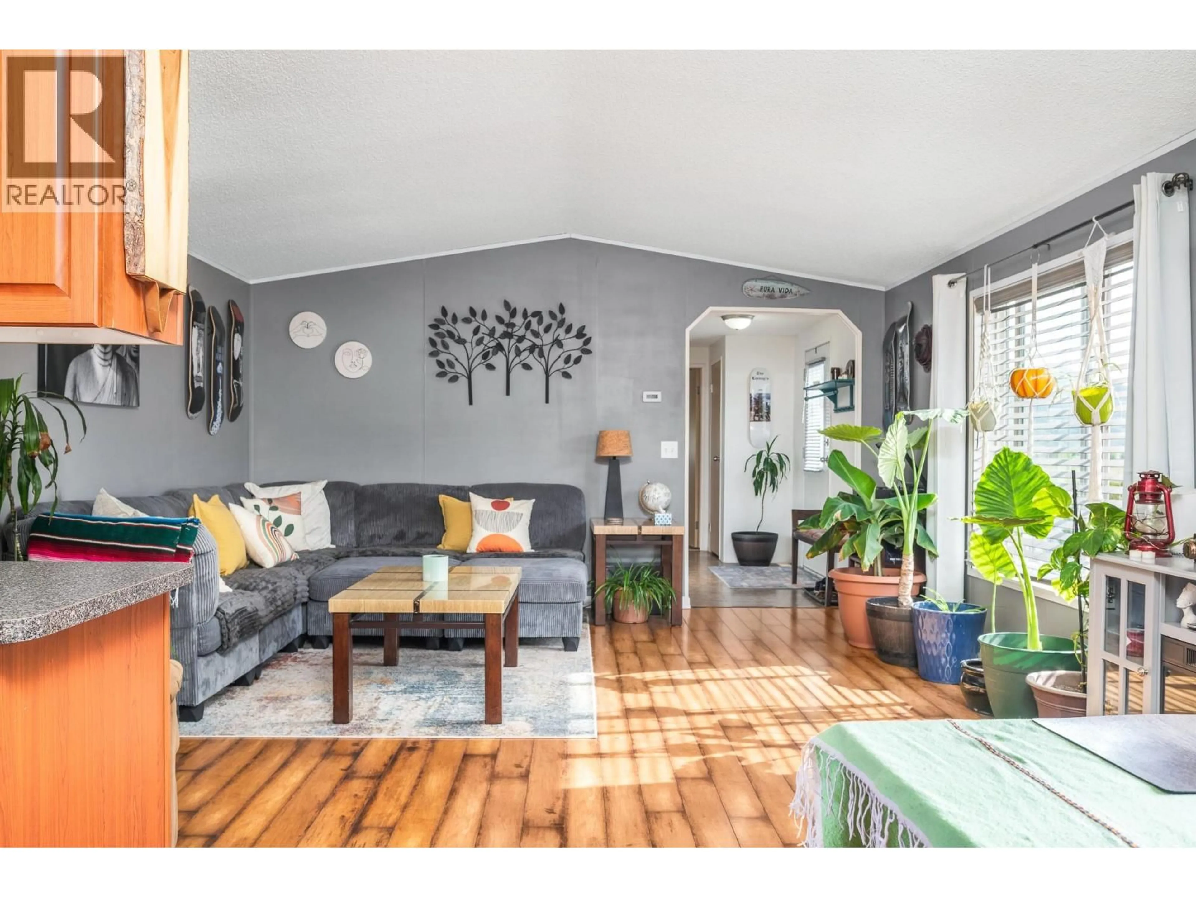Living room with furniture, wood/laminate floor for 10 - 12560 WESTSIDE ROAD, Vernon British Columbia V1H1S9