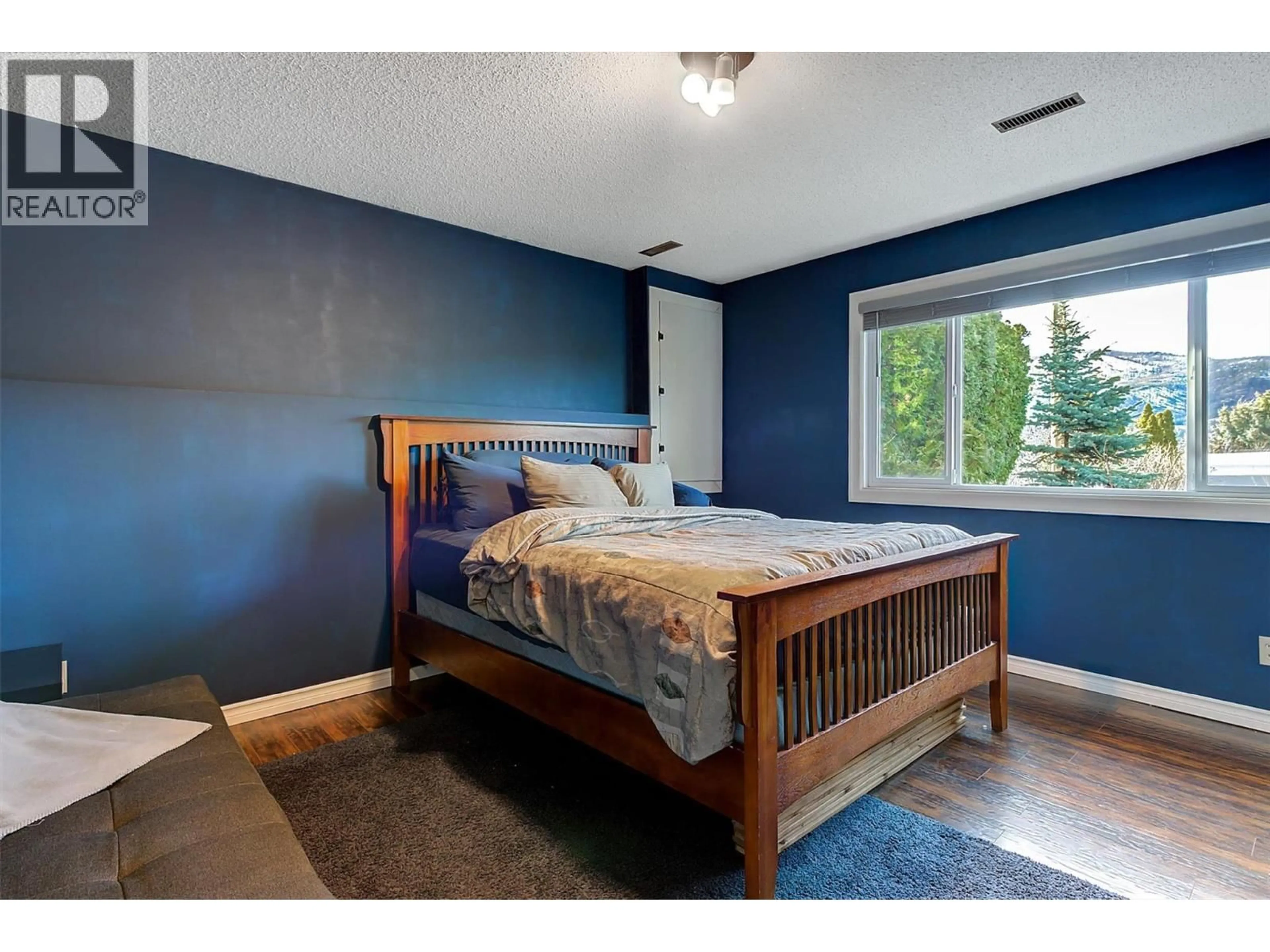 Bedroom with bed, wood/laminate floor for 2415 COLLINGWOOD ROAD, West Kelowna British Columbia V1Z2C3