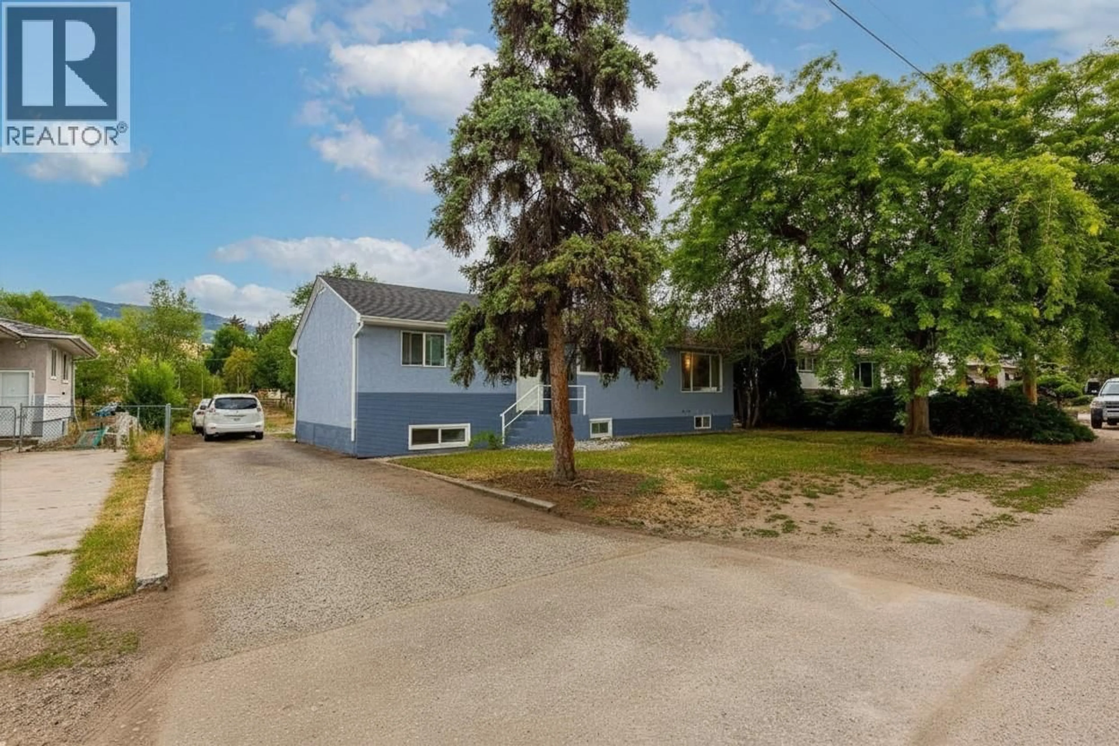 A pic from outside/outdoor area/front of a property/back of a property/a pic from drone, street for 525 DONHAUSER ROAD, Kelowna British Columbia V1X3G1