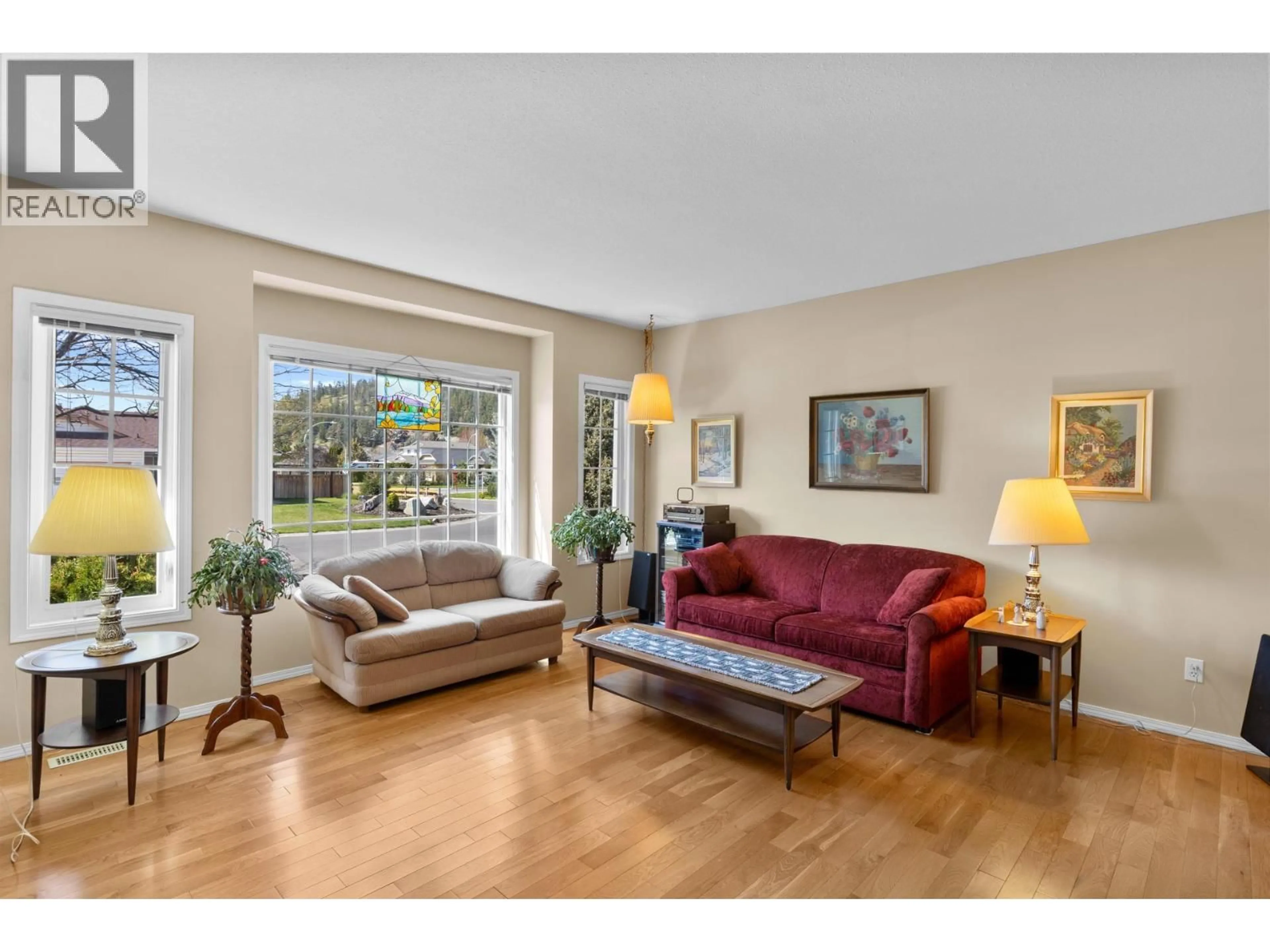 Living room with furniture, wood/laminate floor for 390 MCTAVISH CRESCENT, Kelowna British Columbia V1V1P1