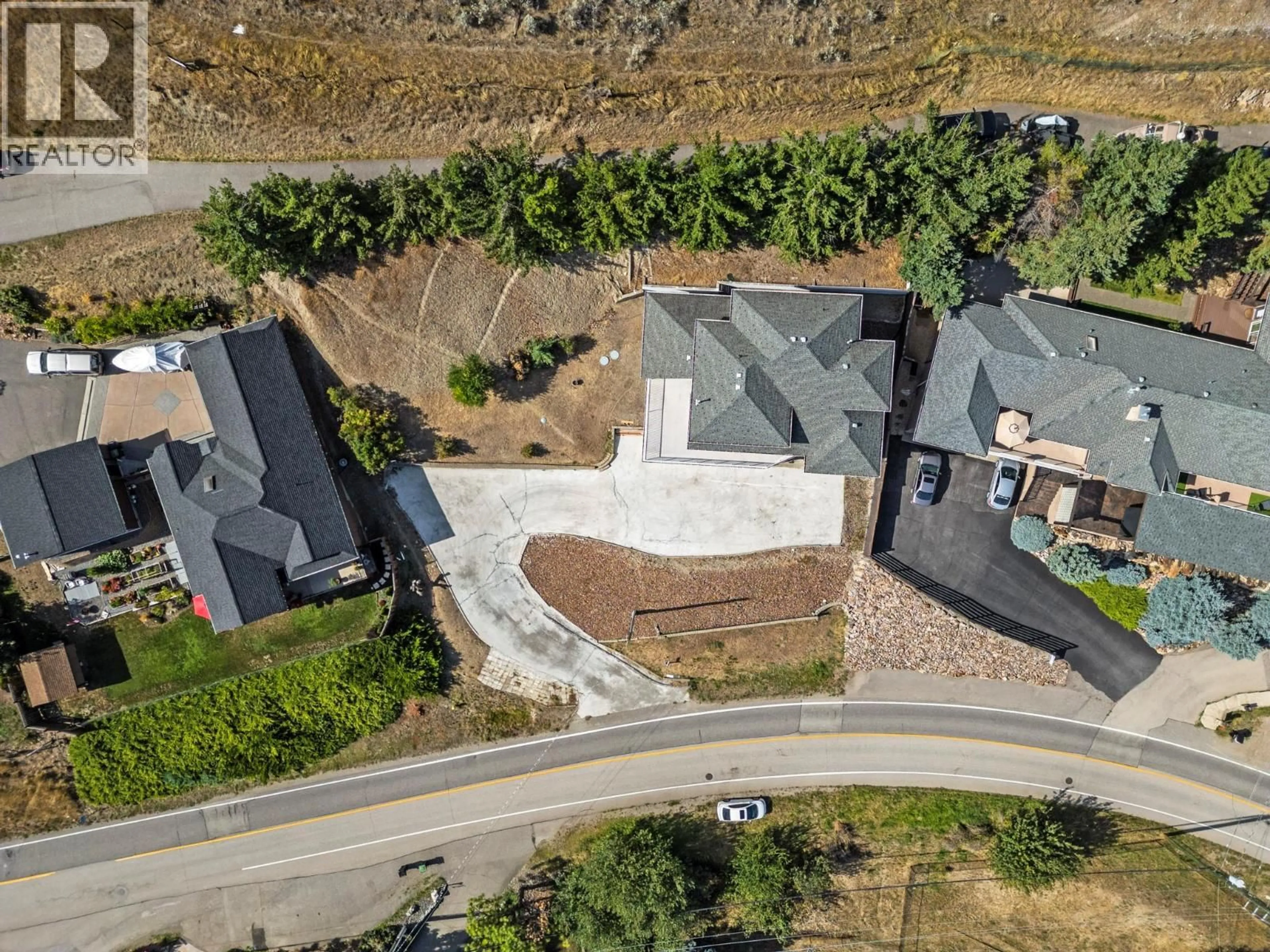 A pic from outside/outdoor area/front of a property/back of a property/a pic from drone, street for 7967 TRONSON ROAD, Vernon British Columbia V1H1C6