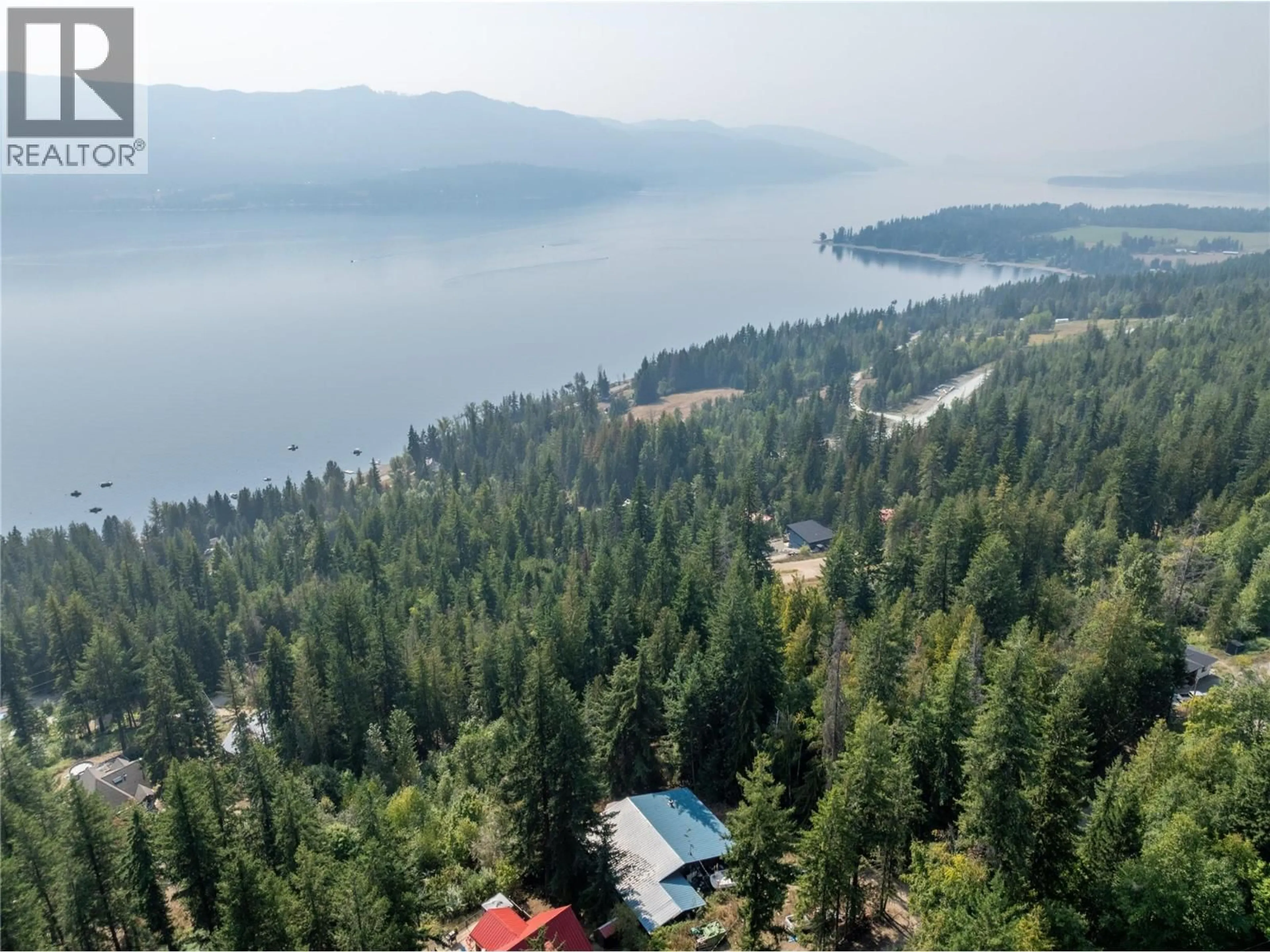 A pic from outside/outdoor area/front of a property/back of a property/a pic from drone, water/lake/river/ocean view for 7578 STAMPEDE TRAIL, Anglemont British Columbia V0E1M8