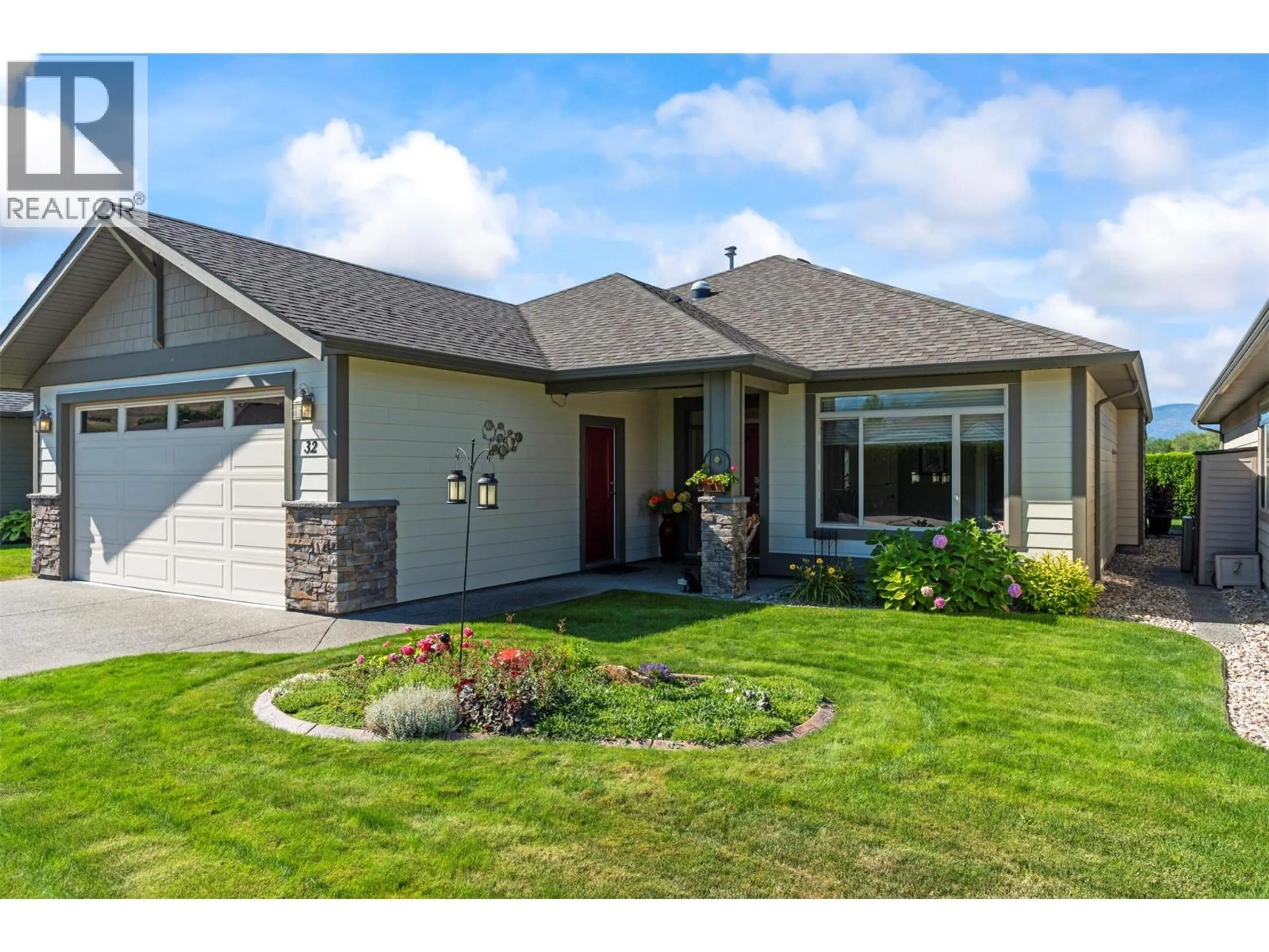 Home with vinyl exterior material, street for 32 - 6450 OKANAGAN LANDING ROAD, Vernon British Columbia V1H2H5