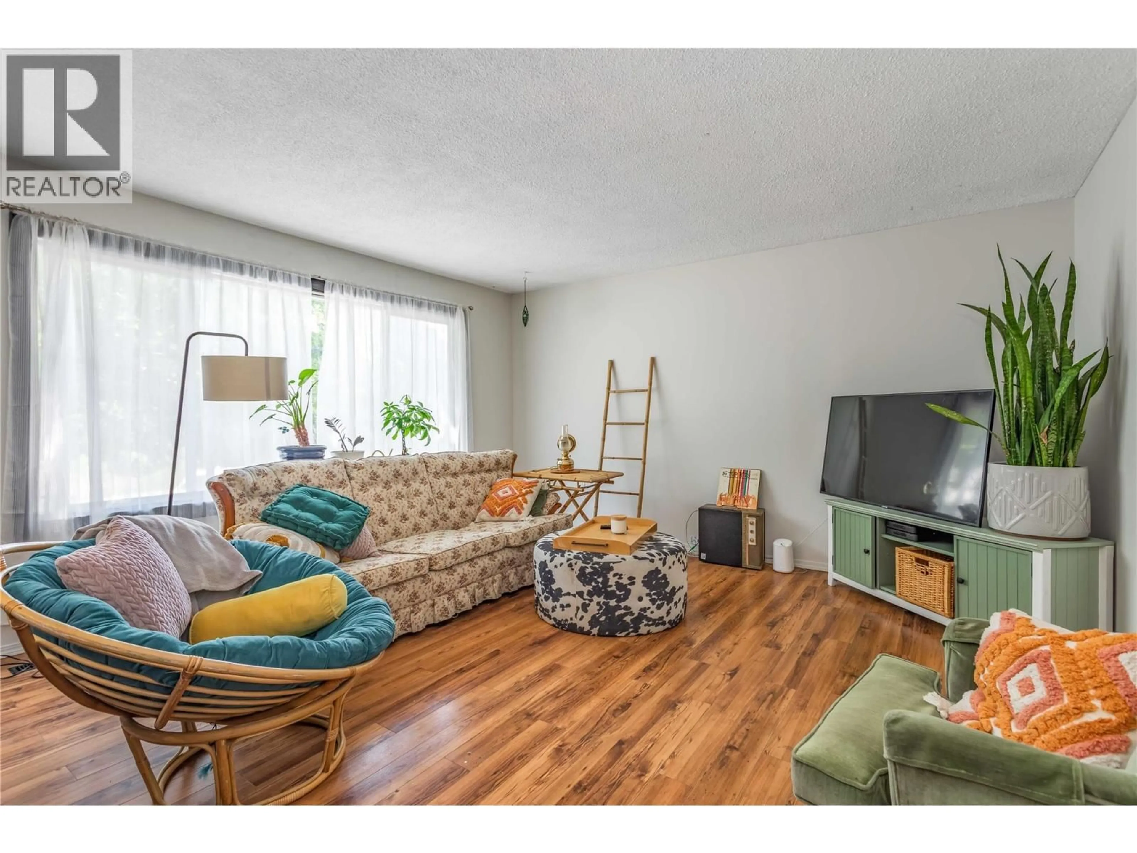 Living room with furniture, wood/laminate floor for 1560 PONDEROSA ROAD, West Kelowna British Columbia V1Z1N1