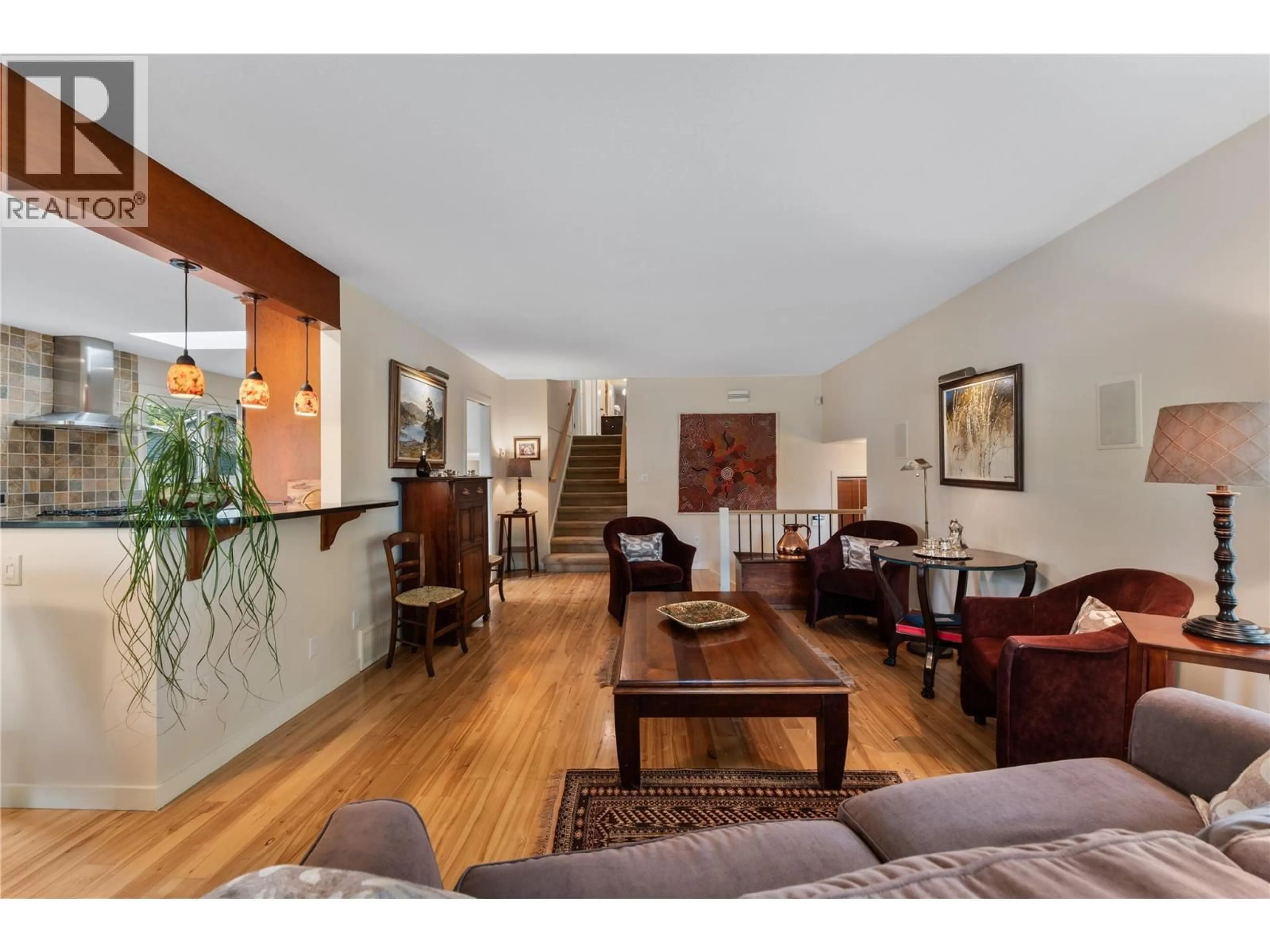 Living room with furniture, wood/laminate floor for 4495 SWAISLAND ROAD, Kelowna British Columbia V1W1Y8