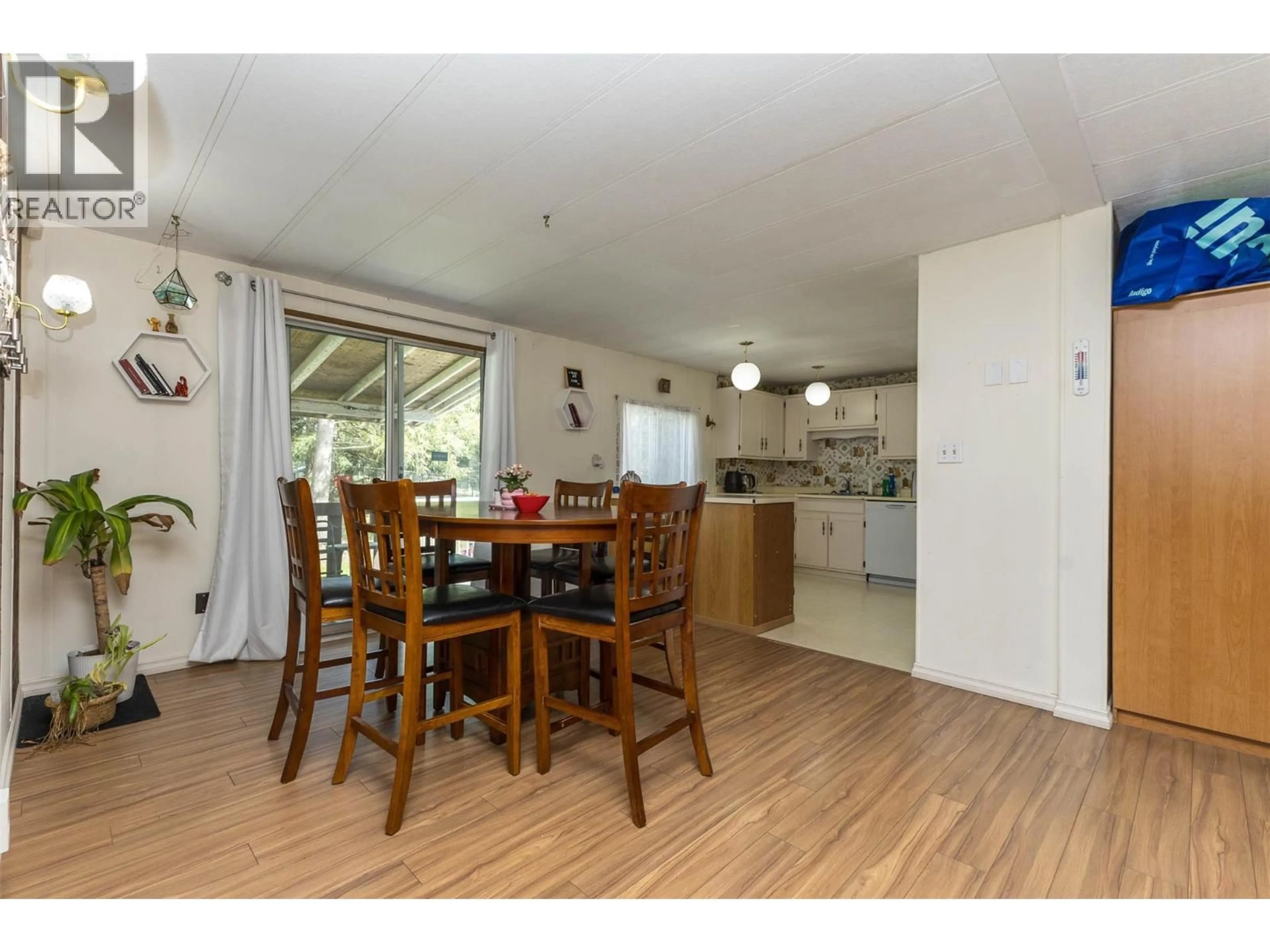 Open concept kitchen, wood/laminate floor for 167 - 2500 97B HIGHWAY SOUTHEAST, Salmon Arm British Columbia V1E1C3