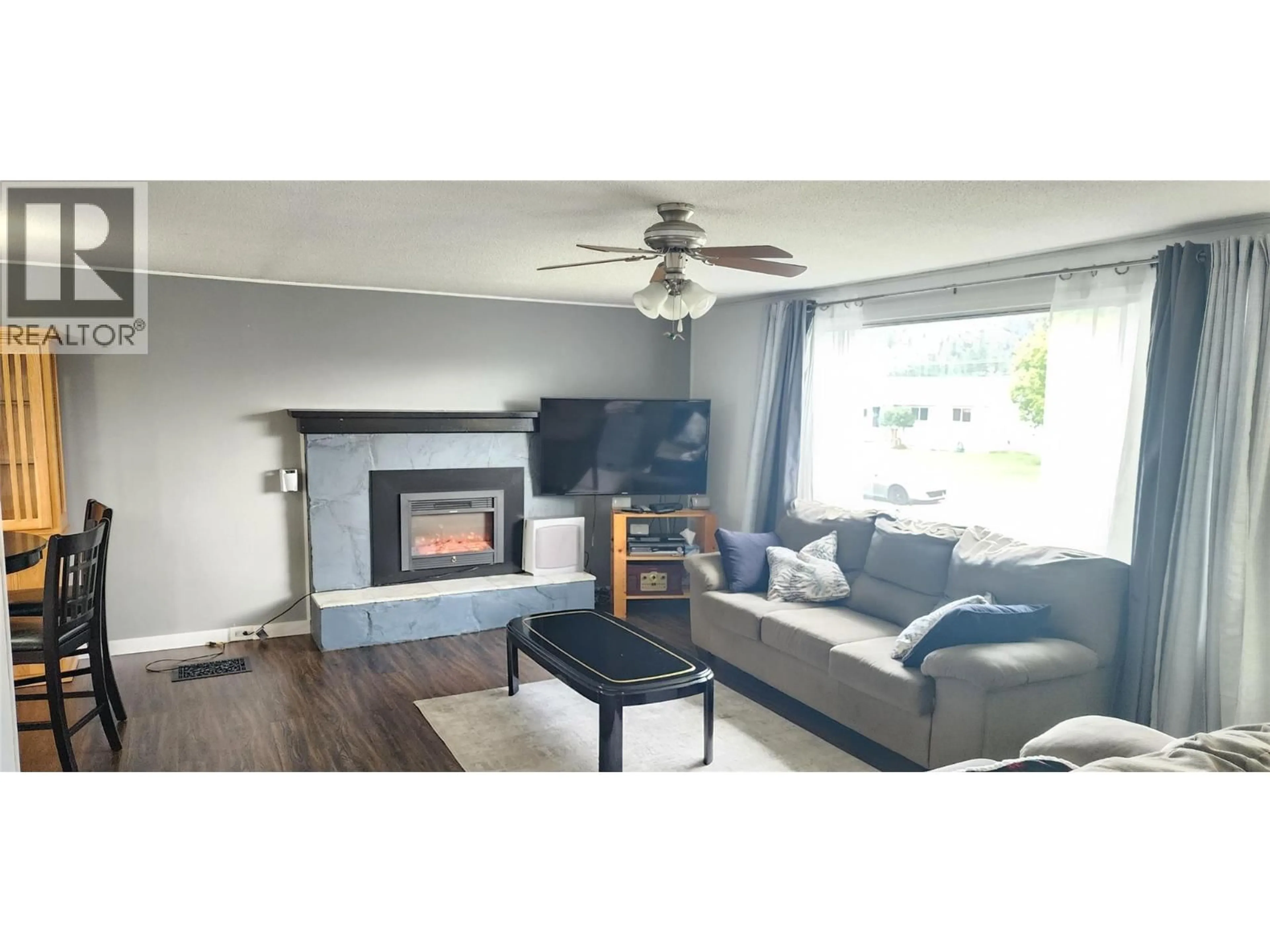 Living room with furniture, wood/laminate floor for 7827 22ND STREET, Grand Forks British Columbia V0H1H2